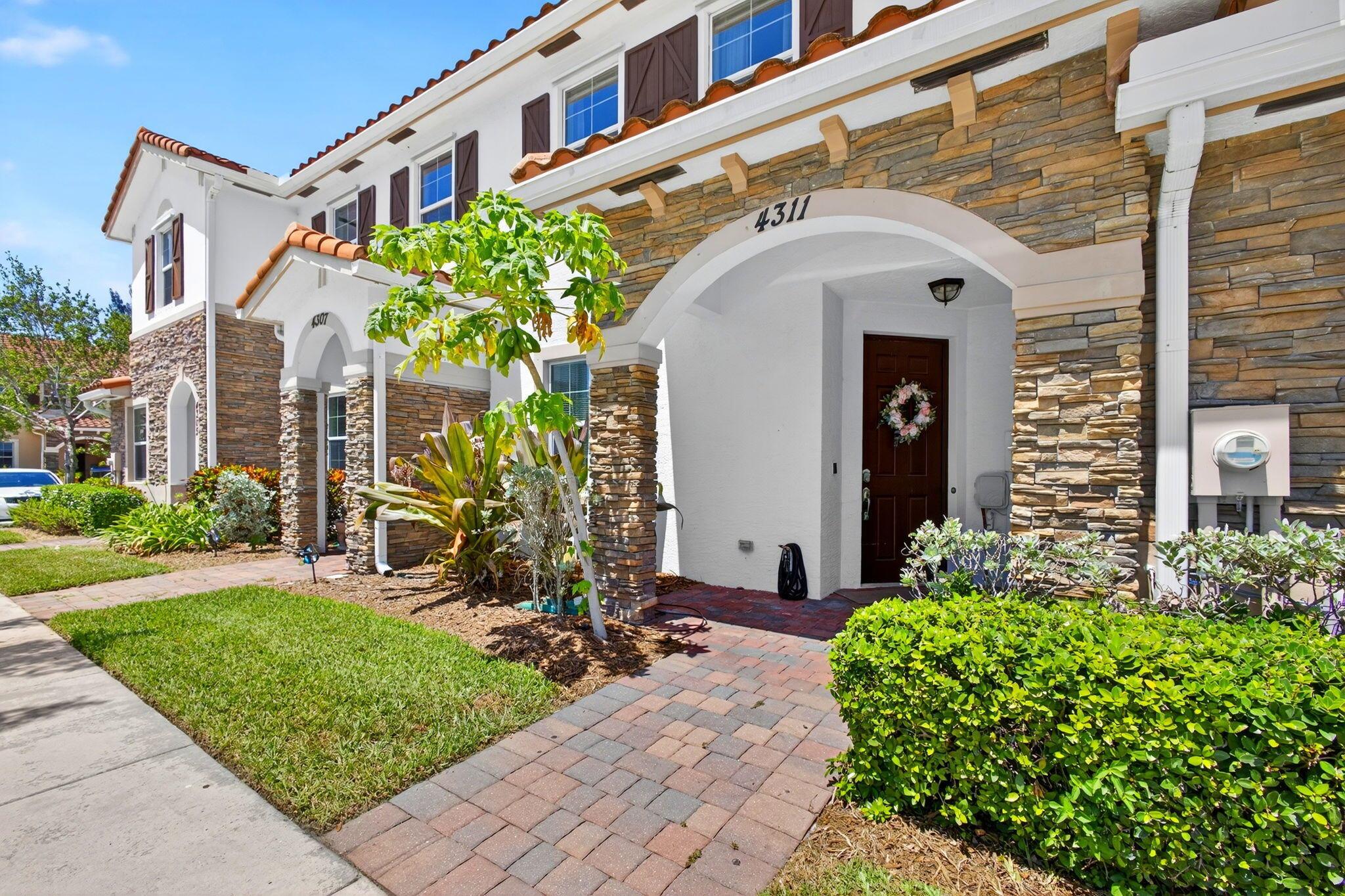 Welcome to 4311 Maybelle Lane - a beautifully maintained townhouse nestled in a desirable gated community in the heart of West Palm Beach. This spacious 3-bedroom, 2.5-bathroom home has brand new flooring on the stairs and second floor, and offers the perfect blend of comfort, style, and modern living. Step inside to find an open-concept layout with soaring 9-foot ceilings on both levels. The kitchen features granite countertops, wood cabinetry, and stainless steel appliances. Upstairs, you'll find three generously sized bedrooms, all offering ample closet space and natural light. Step outside to a back patio with no rear neighbors, providing extra privacy. Enjoy access to community amenities like a pool and playground, all just minutes from premier shopping, dining, and major highways.
