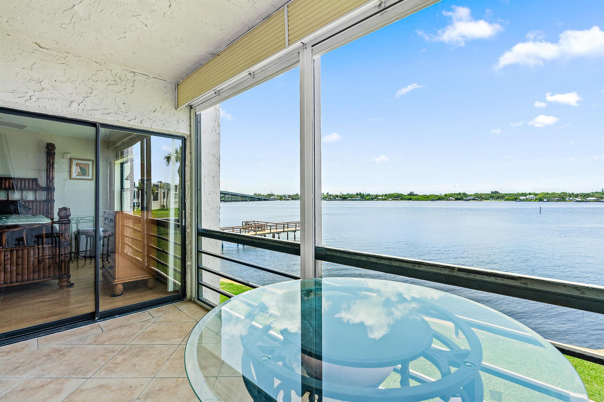 Enjoy stunning WIDE WATER VIEWS all winter long in this beautifully updated riverfront condo, in the desirable Circle Bay Yacht Club. This 2-bedroom, 2-bath unit features an updated kitchen with custom cabinetry, granite countertops, and sleek laminate wood flooring that flows seamlessly throughout the living areas. Both bathrooms have been tastefully renovated, offering modern finishes. Start your mornings with coffee or wind down in the evenings with a cocktail on the spacious screened patio, where you'll take in panoramic views of the tranquil waters. Minutes from Downtown Stuart's charming shops, dining, and entertainment venues. Circle Bay Yacht Club is more than just a place to live--it's a lifestyle! Residents enjoy resort-style amenities including a heated pool, hot tub, sauna,