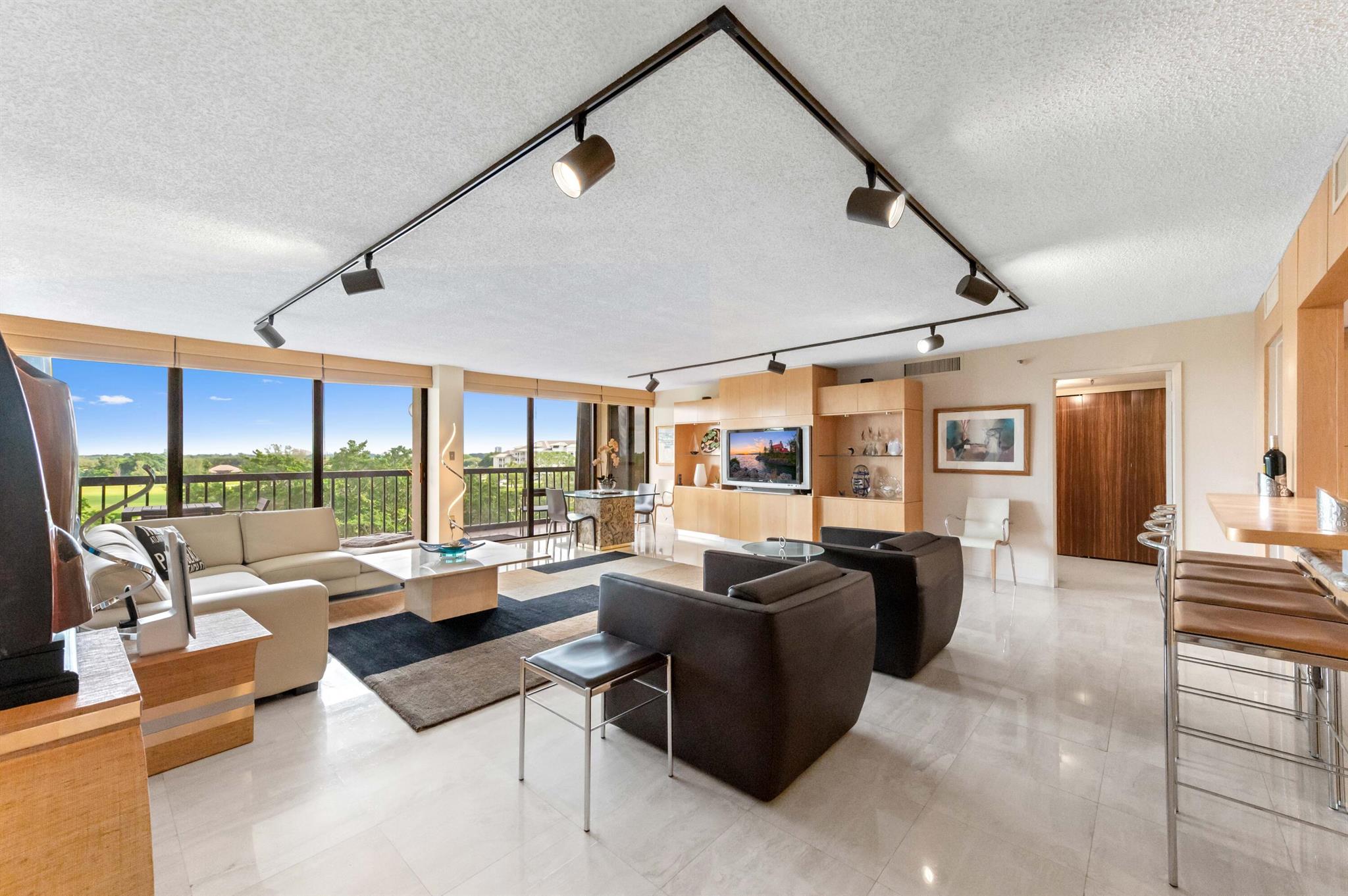 Welcome to this Sublime fully renovated furnished apartment designed by PB renowned Art and Design Co. The apt is located in a very sought-after pet friendly, full service building in the only gated community just east of I-95. The result is a chic comfortable space featuring an open spacious floor plan with gorgeous finishes including oak finishes, marble floors, gourmet Chef Kitchen with top of the line appliances, quartz countertops, custom cabinets, custom wooden doors and frames, gorgeous bathrooms and split large bedrooms. Floor to ceiling sliding door/windows a large balcony offers beautiful views on the well maintained gardens of the association. The Envoy is known to be a very social building with a private ''North One Club'' during the season. 24/7 concierge & manager on site.
