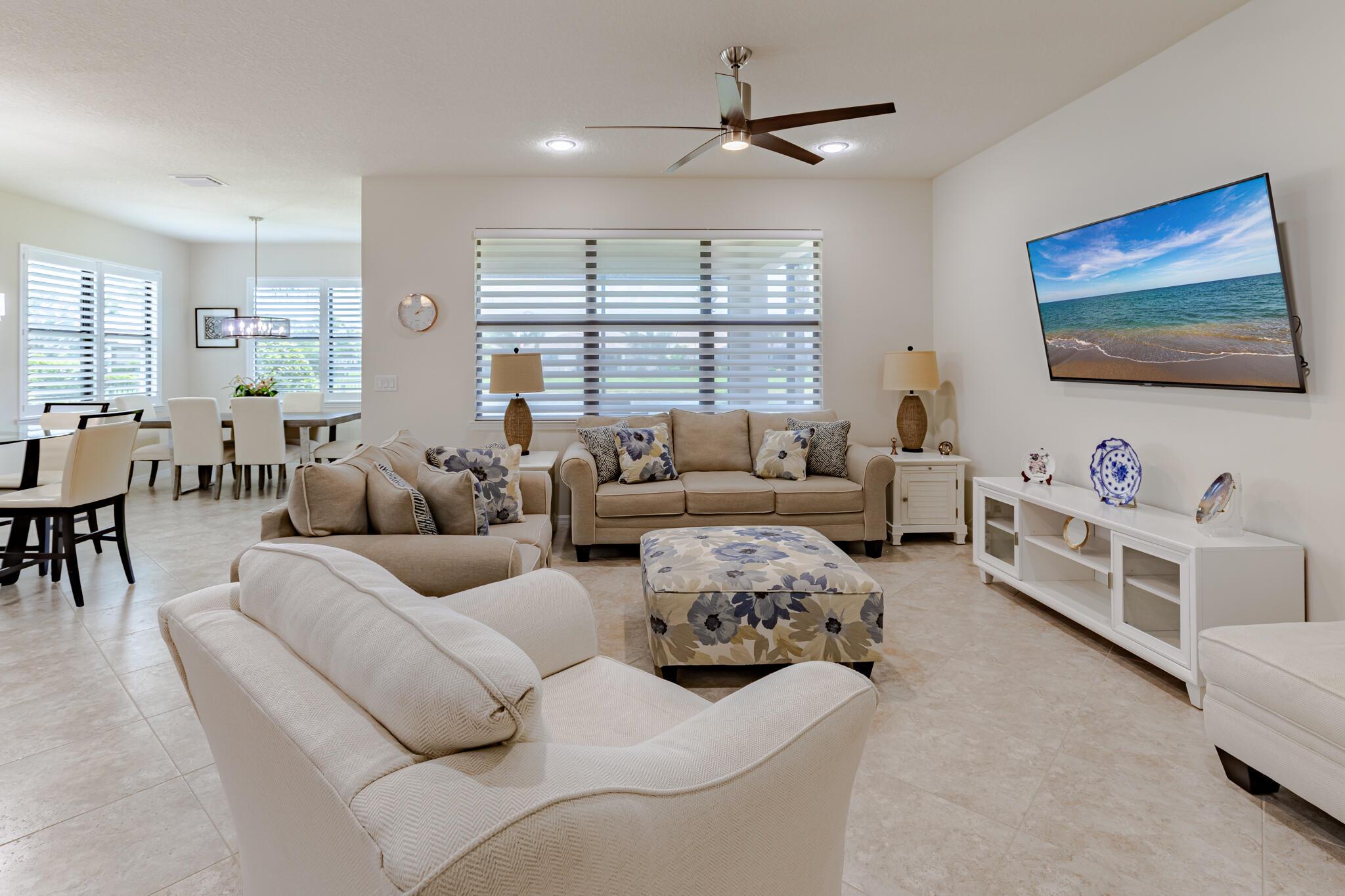 **WOW** REDUCED* Meticulously maintained home offering 2 bedrooms, 2 bathrooms, plus a versatile den/office with French doors. The gourmet kitchen features a large island, GAS range w/hood, SS appliances, stylish backsplash, and designer lighting. The open-concept layout seamlessly connects the kitchen, dining, and living areas. Gorgeous tile flooring throughout. A spacious dining or sunroom leads to the extended screened lanai, where you'll enjoy sparkling lake views and golden sunsets. Master suite is a true retreat with spa-like bath with walk-in shower, dual sinks, walk-in closet w/built-in shelving. Additional highlights: laundry room w/storage, 10' ceilings, plantation shutters, remote blinds, 8-ft doors, ceiling fans, smooth-finish walls and IMPACT windows. New A/C and water heater