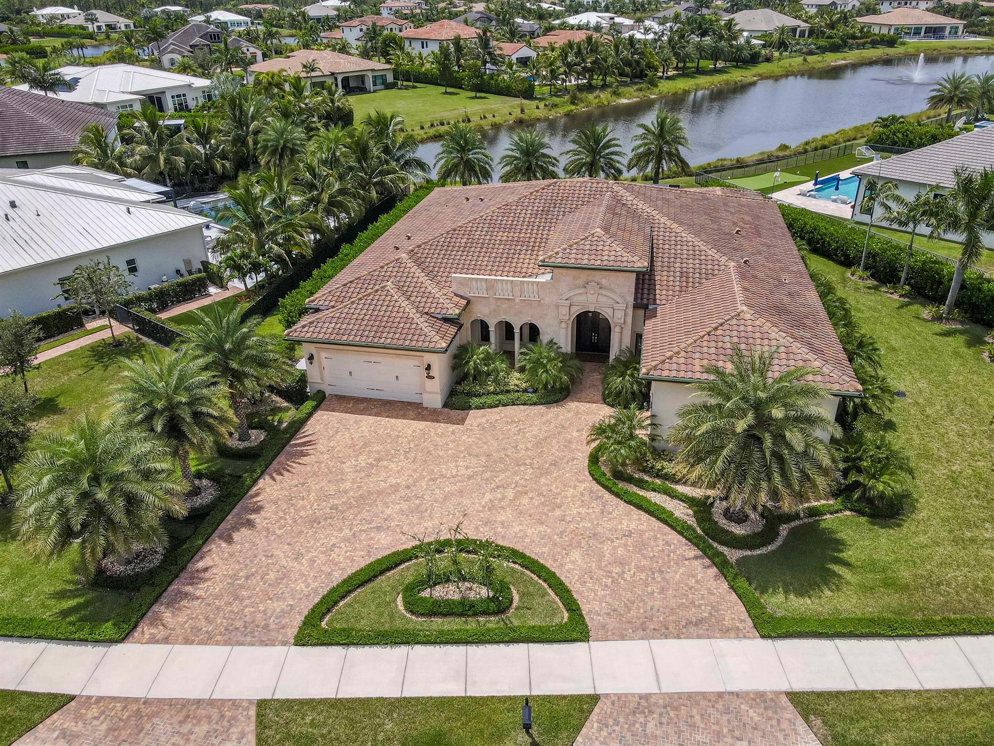 EXQUISITELY APPOINTED one-story Hampton model with breathtaking long lake views in the luxury gated community of Prado is now available! This private retreat is situated on a .53 acre premium homesite and boasts 5 bedrooms + flex room (or 6 bedrooms), 5 1/2 baths, a 3 car garage, horseshoe driveway and 4,317 sf of living area. This ultra private lot offers lovely lake views from the rear and a lush preserve area in the front with no neighbors across the street. Built in 2021, extensive improvements were added after the home was built. Countless interior designer upgrades flow throughout including wide-plank hardwood flooring, solid core doors, plantation shutters, tray ceilings with tongue & groove, crown molding, custom cabinetry, quartz & granite bullnose countertops...and so much more.