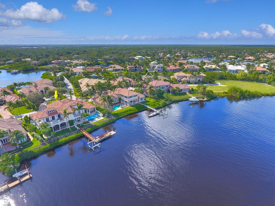 Escape to this custom, waterfront beauty in the heart of Jupiter! A resort like atmosphere outside and a smart, gracious floor plan fit for a crowd inside! Built in 2007, solid concrete construction and superior finishes are immediately evident at every turn. A covered entryway leads to solid mahogany doors with striking beveled glass that offer a glimpse of the majesty that lies ahead. Proper foyer, sprawling two story living area with 28 foot tray ceilings, wide water views, flickering fireplace and a stately staircase create a breathtaking and lasting first impression. Oversized spaces and casual elegance are a constant in the interior designs masterfully created by locally acclaimed McRoberts' Interiors. The tranquil flow and peace found on the waters' edge behind this showplace