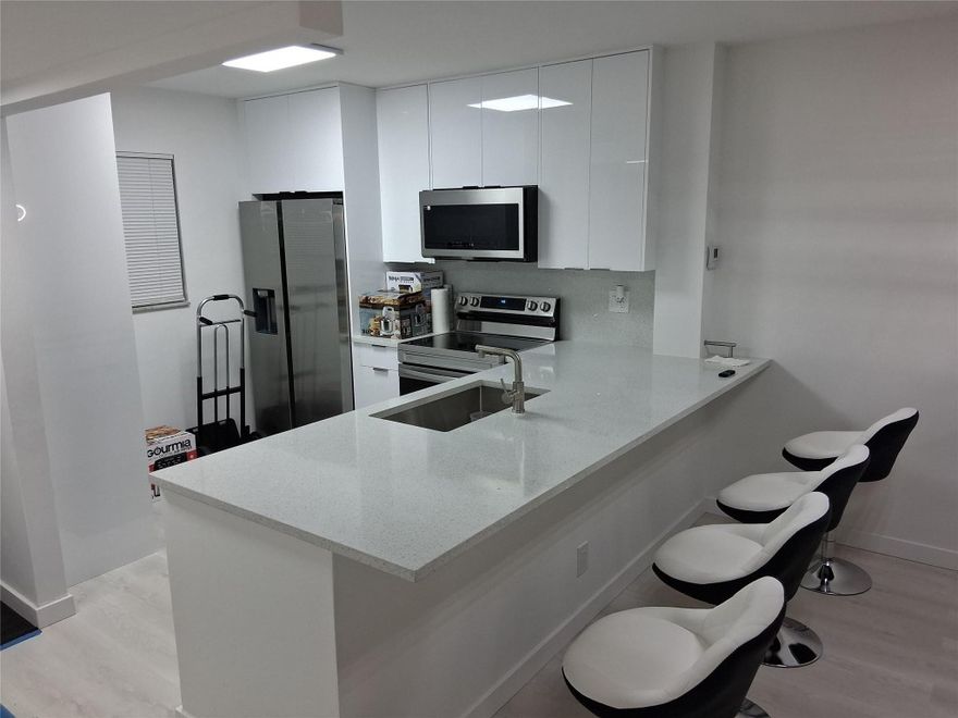 Lovely, spacious, quiet condo in a much sought after, Peaceful Lakeside, Gated community.  everything else is yes has a new instant hot water heater everything inside is brand new from floor to ceiling completely remodeled new high efficiency appliances and Lighting. Modern new bathrooms and tiles. high quality Cabinetry. Beautiful flooring. New closets, doors, mirrors, ceilings and walls Neutral colors. New High efficient impact glass hurricane proof windows. Live a glamorous lifestyle. You can put that first. Includes cable water, several recreational areas.Gym with sauna Steam and showers. Pool tables, ping pong bingo card room, events. Barbecue, Tennis, basketball shuffleboard. 40-year inspection and assessment already completed and paid for. Can rent great investment property