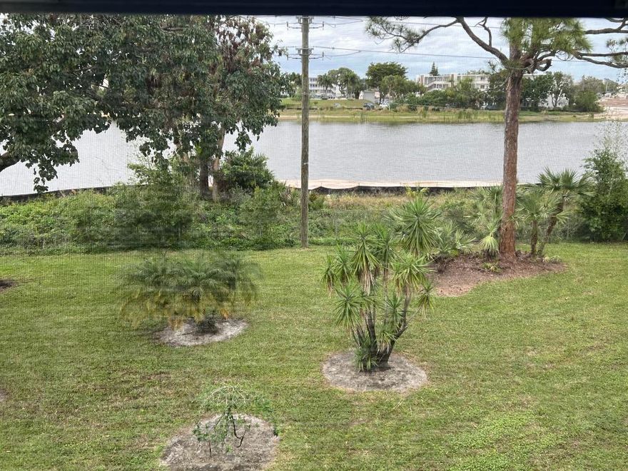 Immaculate updated property with a serene water view from your oversized lanai.