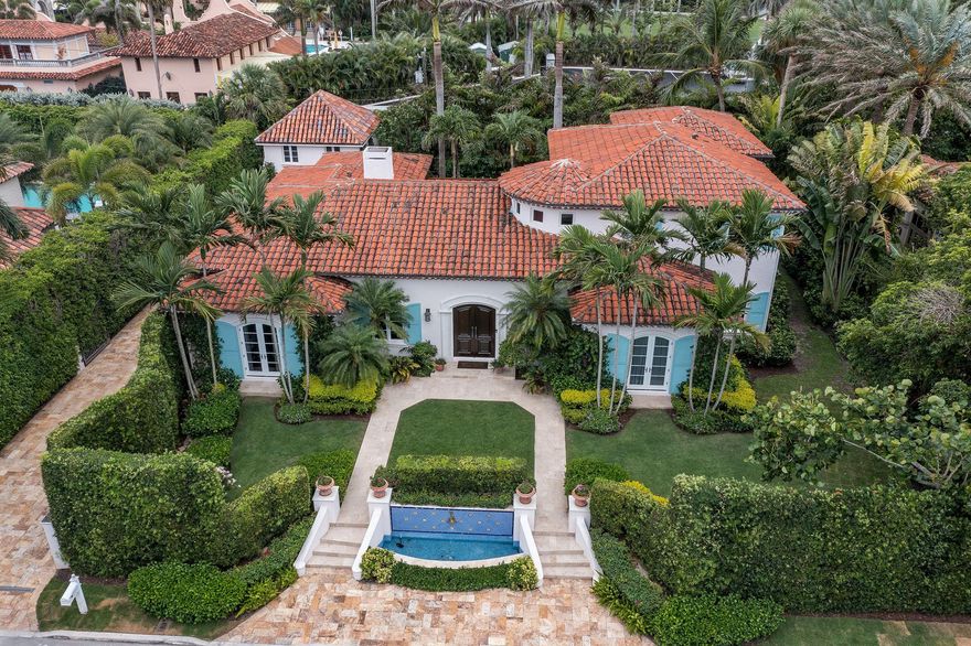 Enjoy this beautiful mediterranean 4BR/5BA home with 1BR/1BA carriage house in the Estate Section with waived Mar-a-Lago initiation fees.  The lushly landscaped exteriors include heated pool and spa, private beach access, built-in BBQ and gated drive. Interiors are professionally decorated and include gourmet chef's kitchen, formal dining room and large living room with fireplace.  The elevator provides additional access to upstairs master suite with his and hers bathrooms and closets.