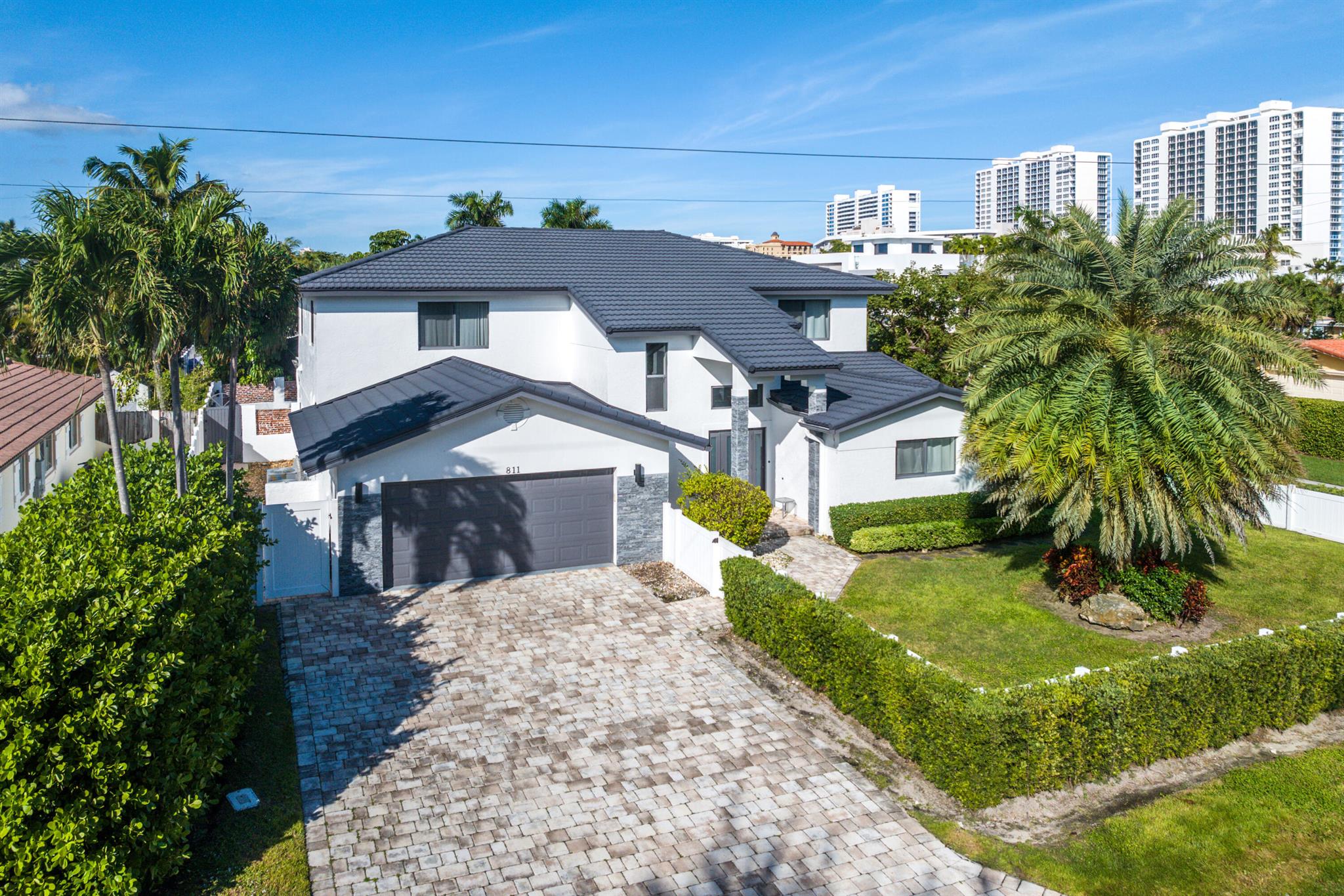 Welcome to your dream coastal retreat--just a short stroll from the sun-drenched shores of Boca Raton. Perfectly situated in the coveted Spanish River Land neighborhood, this stunning residence offers the ideal blend of beachside living, luxury design, and premier East Boca Raton lifestyle.Set on an expansive, fenced lot, this beautifully remodeled home features a seamless indoor-outdoor flow with lush green space, a saltwater pool, and a 12-person spa--ideal for entertaining or relaxing in your private oasis. Inside, a thoughtfully designed open-concept layout includes six bedrooms and five full bathrooms, with both first and second-floor primary suites. Each guest room includes its own ensuite bath, ensuring comfort and privacy for all.