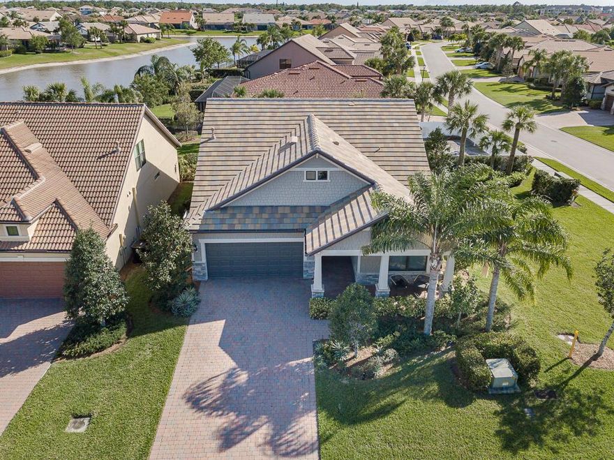 **PRICE IMPROVEMENT**  Impeccable 4/3/2, great room, sunroom & loft.  Kitchen features Samsung Bespoke 4-Door French Door Smart Refrigerator, large island w/granite countertops, gas stove, upgraded cabinets, faucet & beautiful pendant lighting. Eating area next to relaxing sunroom/reading room/hobby room. Levolor blinds, ceiling fans, gorgeous luxury vinyl plank flooring throughout home!!!  Dual sinks, granite counters, large shower with decorative tiles, in primary bath. Spacious walk-in closet. Second Floor features large loft, bedroom, bathroom, and lots of storage! Covered lanai w/ fenced in backyard, on corner lot, w/oversized easement. HUGE Bonus Net Zero Solar Powered Smart Home.  2 Tesla Power Walls Batteries & FAST EV Charger. Gated community w/resort pool, spa, gym, tennis, pic State-of-the-Art Clubhouse with resort-style heated pool and spa, lap pool, cabanas, outdoor barefoot bar, BBQ grills, fire pit, community activity room, catering kitchen, indoor fitness center, outdoor gym, tennis courts, bocce ball courts, pickleball court, basketball court, dog park, tot lot playground, lakefront event lawn and pavilion, manager on site, streetlights, sidewalks. Fun for all ages. Come play where you live!!!