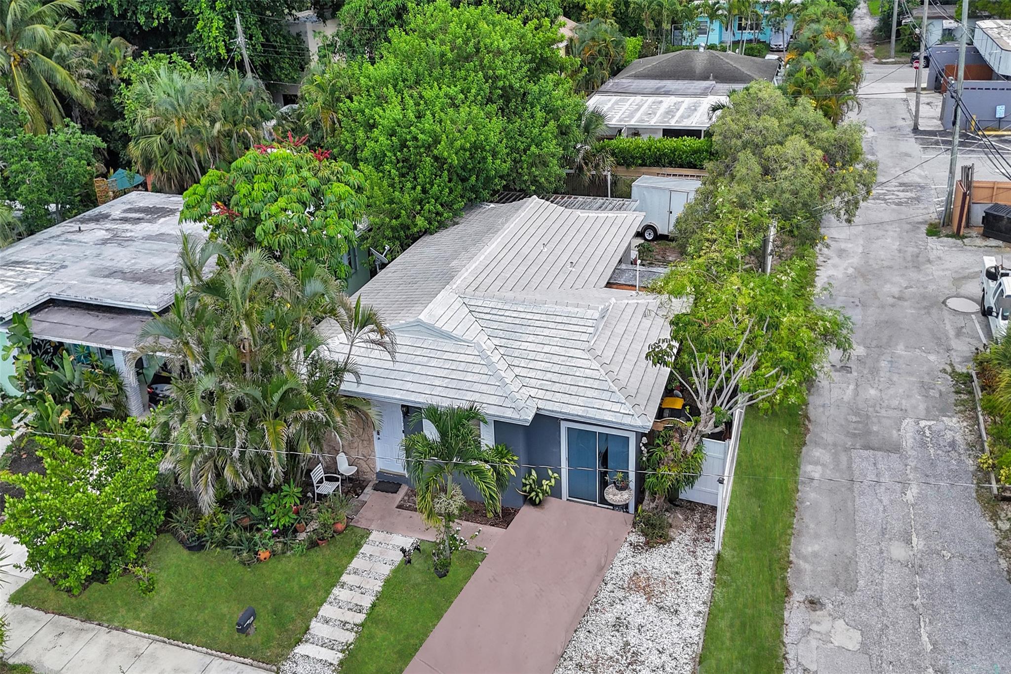 Nestled in the College Park Section of Historic Lake Worth Beach, this 3 bedroom, 2 bathroom home offers a cozy living space, tile floors all throughout and private backyard. The second bedroom features French doors connecting to the screened in patio. Multiple entry points provide added convenience, Updated Fence 2021 ensures both security and seclusion. No HOA | ROOF ONLY 9 YEARS OLD & recently power washed | Electrical Panel 2020 | Water Heater 2020. Conveniently located East of N Dixie Highway, residents enjoy a blend of historic charm and vibrant community life. Close to dining, shopping, and beaches; I-95, Tri-Rail at Lake Worth station, and Palm Beach International Airport are all within a 10–15 minute drive.