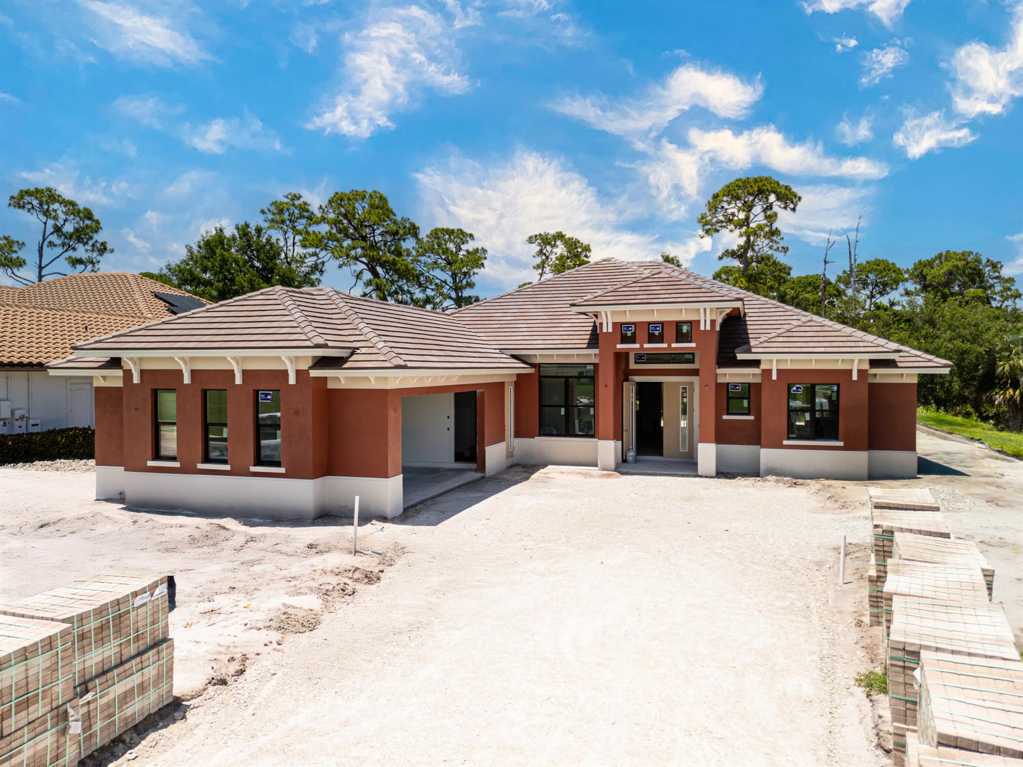 Completion AUG. 2025. This is the only home of its kinda"a custom, never-before-built design in the gated community of Rivella, set on a premium corner lot with preserve views. Inside, youa(tm)ll find 12a(tm) ceilings, exposed beams, and triple impact sliders leading to a covered lanai with outdoor kitchen and fireplace. The chefa(tm)s kitchen includes quartz counters, custom cabinetry, and a walk-through butlera(tm)s pantry. The primary suite offers a freestanding tub, oversized shower, and full privacy. Enjoy walkable access to the clubhouse, pool, and tennis. Located near Jensen Beach, downtown Stuart, botanical gardens, and upscale shopping. No closing costs with preferred lender.