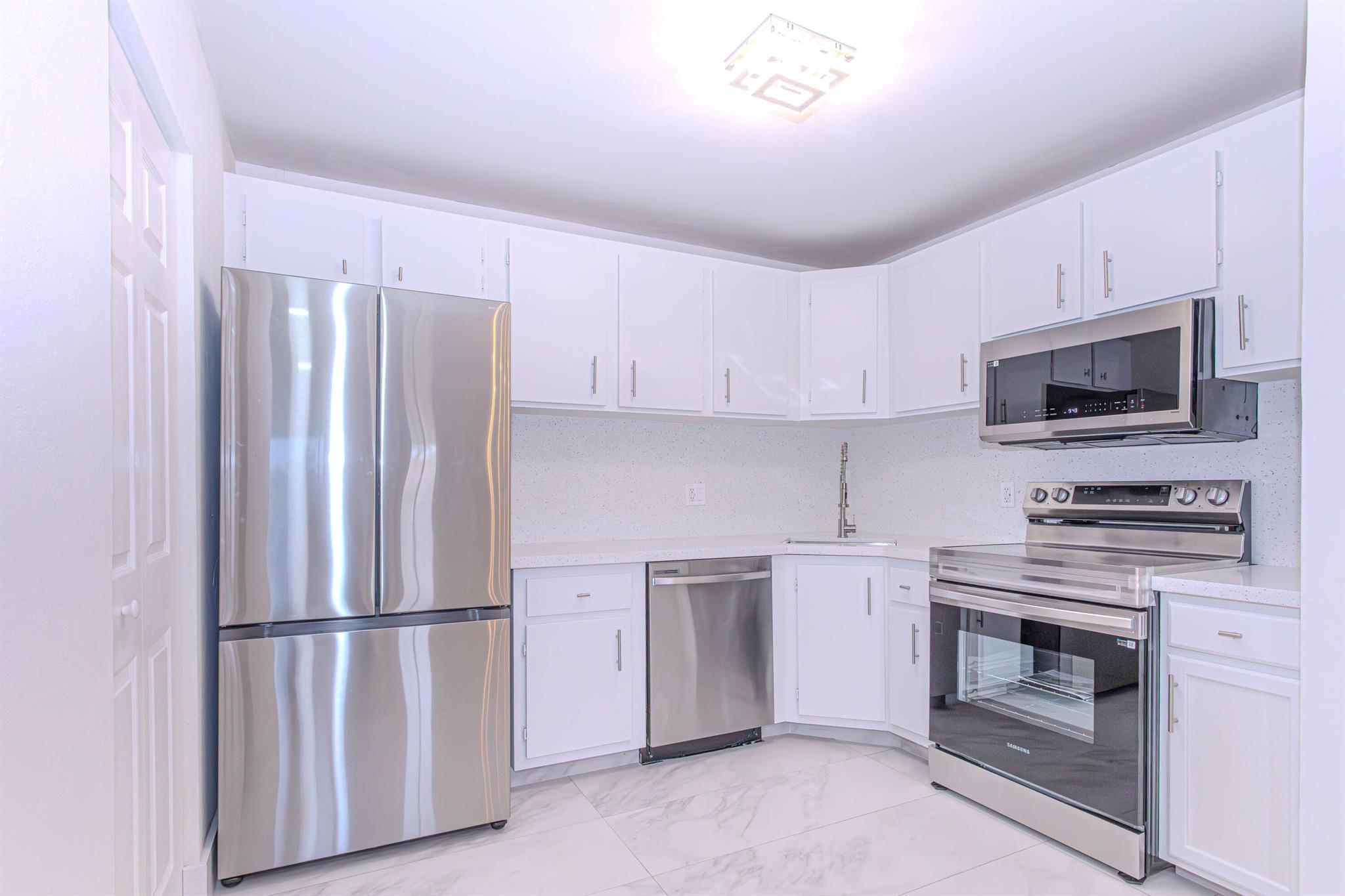 Fully Renovated & Move-In Ready Condo! This beautifully updated 2-bedroom, 2-bathroom condo offers modern living with a spacious open-concept layout and high-end finishes throughout. The kitchen features brand-new appliances, including a microwave with built-in air fryer functionality--perfect for convenience and healthy cooking. Enjoy new laminate flooring throughout the entire unit, creating a fresh and cohesive look. The open dining and living area is ideal for both relaxing and entertaining. Both bedrooms include large walk-in closets, and the unit offers the convenience of in-unit laundry and a generous storage room.Ideally situated near Jog Road and Forest Hill Boulevard, this home offers easy access to parks, shopping plazas, restaurants, and everything you need just minutes away.