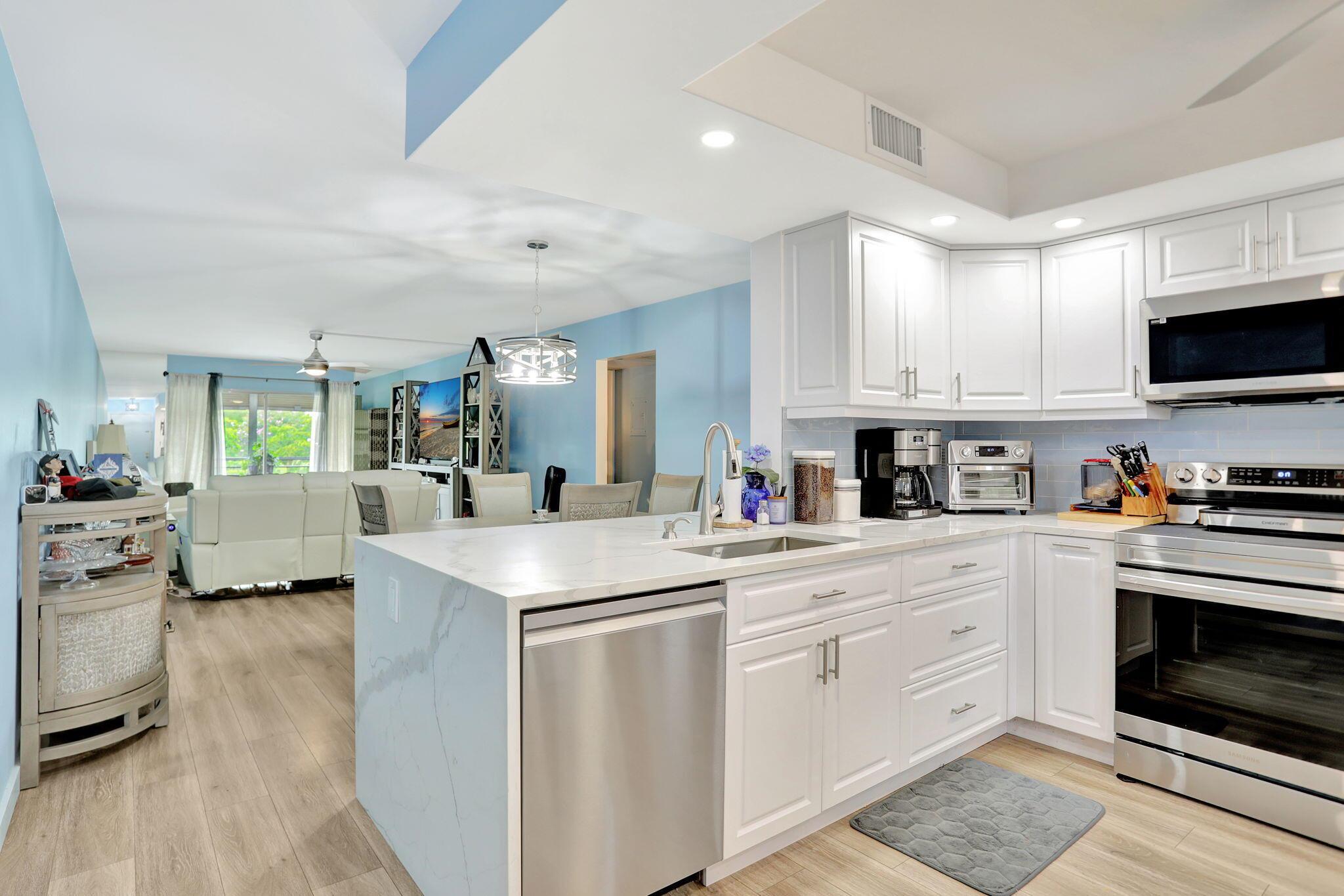 South Florida lifestyle at its finest! Beautifully renovated and move in ready, 2 bedroom 2 bathroom elegant retreat in the heart of Wynmoor Village. Favored for its proximity to the newly refurbished pool and the communities many amenities, the unit enjoys a serene lake and fountain views. Thoughtful design features include custom cabinetry, allowing for ample extra storage, solid granite and quartz countertops, newly renovated kitchen with high end stainless steel appliances, elegant fixtures, new ceiling fans and tasteful wood look flooring throughout. Wynmoor Village is renowned for its extensive amenities and activities and considered to be among the top Active Adult communities in the nation!