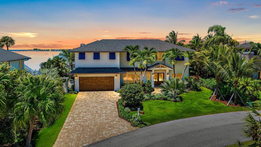 Welcome to your coastal sanctuary in Joe's Point on Hutchinson Island, where luxury meets serenity. This stunning waterfront estate offers the ultimate in coastal living.  You have the Intracoastal Waterway right at your doorstep plus your own private beach access across the street. Completely remodeled down to the studs with meticulous attention to detail, this residence boasts the true ''Old Florida'' elegance with a timeless design. As you enter, you'll be greeted by expansive water views and an abundance of natural light. The traditional layout is perfect for both entertaining and relaxing, featuring stunning hardwood floors, a gourmet kitchen with top-of-the-line appliances (Wolf and Subzero), custom cabinetry, marble countertops and exquisite finishes.