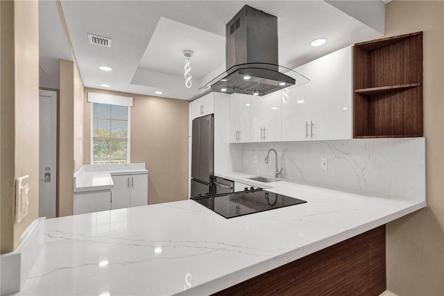 Just listed! Meticulously upgraded 2BR/2BA residence plus a dedicated private office, perfect for remote work. This modern oasis features a designer kitchen with dual-tone cabinetry, stainless steel appliances, an island range hood, and a custom coffee/wine bar. Interior highlights include 6-inch baseboards, integrated LED chrome pendants, and a primary suite with marble countertops and a 2-jet high-pressure shower tower. Relax on the enclosed balcony with serene golf course and canal views—balcony furniture and wall-mounted TV stay for tenant use!  Rent includes: Water, sewer, trash, basic cable, and pool/clubhouse access.