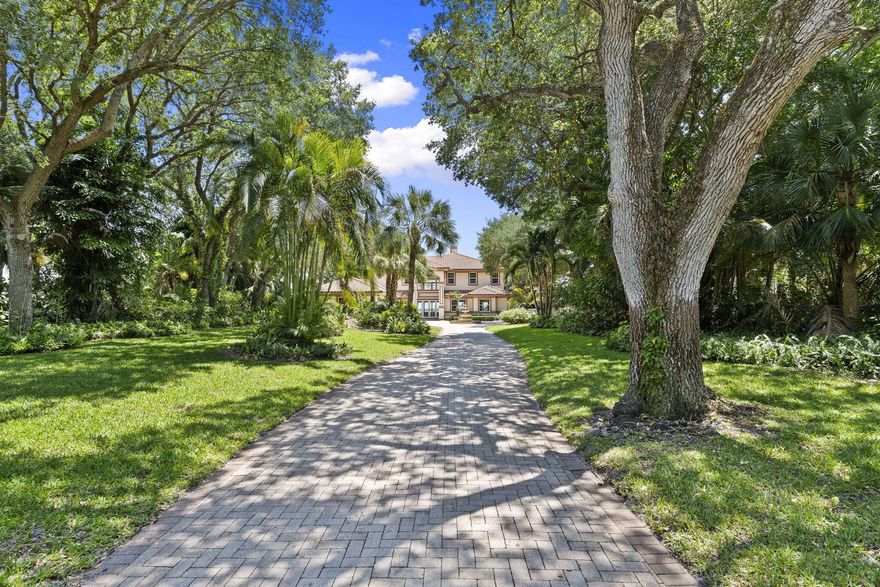 Set on one of the area's most desirable shaded streets, surrounded by estate lots, mature trees, private gated entrances, and a level of privacy that is increasingly hard to find, this Intracoastal estate delivers the kind of waterfront setting buyers wait years for.  Positioned on high elevation with breathtaking water views, the property offers direct Intracoastal frontage, a deep water private dock, coded gated entry, full perimeter fencing, and exceptional outdoor living with a pool and hot tub designed for relaxing, entertaining, and taking in the view.  Inside, the home features 4 bedrooms plus a versatile office or den, 4.5 bathrooms, elegant wood and marble flooring, and impact rated windows and doors throughout.