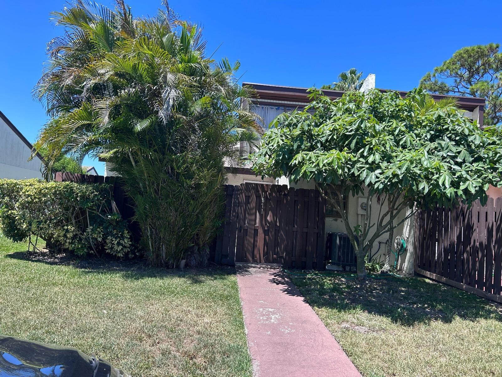 Welcome to this charming 2-bedroom, 2-bathroom townhome, centrally located in West Palm Beach. Enter through a fenced patio area into a bright living space with vaulted ceilings. The kitchen, featuring vintage appeal, adds character to the home. The upstairs loft, with ample natural light, can serve as a third bedroom or office. Each bedroom features well-appointed bathrooms, and the master suite offers a walk-in closet and a step-in shower. The HOA covers lawn maintenance, common areas, irrigation. Enjoy community amenities including a pool. This home perfectly combines comfort and convenience. With some TLC this townhome has all the potential to be transformed into a Masterpiece of a townhome. Do not Miss Out! Schedule a Viewing today!