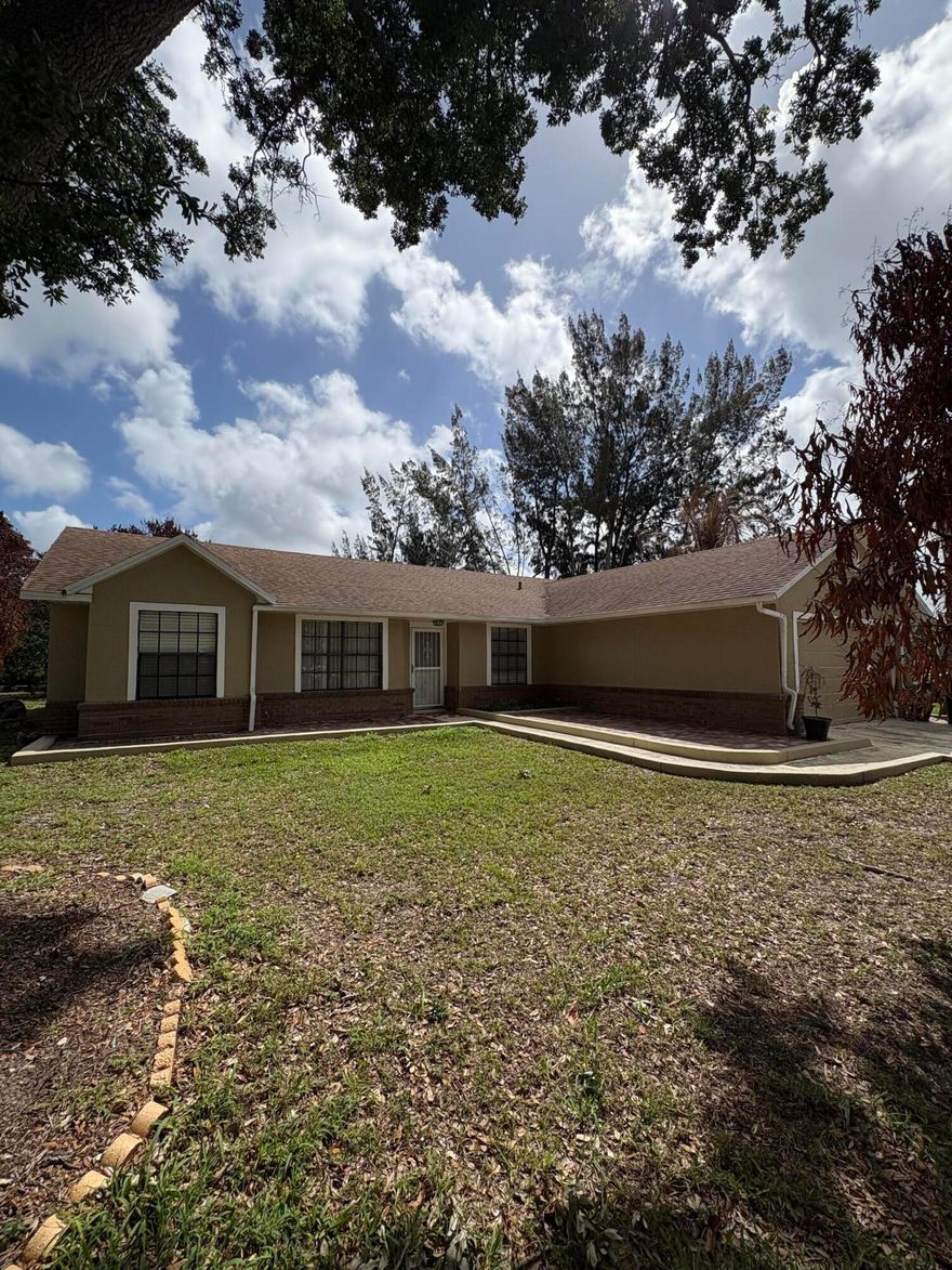 Charming 3-bedroom, 2-bath home situated on an oversized lot in the heart of Port St. Lucie. This property offers the perfect blend of comfort and space and features a bright and open floor plan ideal for both everyday living and entertaining. The kitchen boasts a center island, perfect for meal prep and gathering, and flows seamlessly into the living and dining areas. Major upgrades include a new roof (2022) and AC system (2021), providing peace of mind for years to come. Oversized yard, ideal for outdoor entertaining, gardening, or even adding a pool. With plenty of room for boats, RVs, or future expansion. Located directly across the street from a park. Conveniently close to shopping, dining, schools, and major highways.