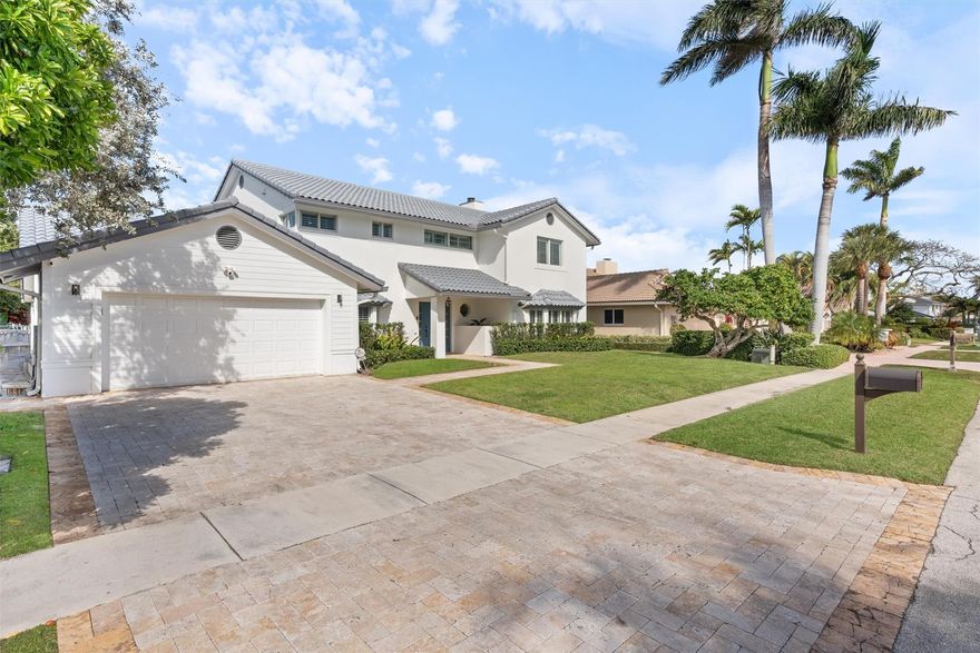 Coastal farmhouse perfect for entertaining with plenty of room for a large family! This amazing home offers 80 feet of deep water dockage and a 14K lbs. boat lift, situated in a low traffic location on 47th Street.  There are 4 beds and 2 baths upstairs with a guest bedroom, full cabana bath, and half bath downstairs.  The large open eat-in kitchen connects to the family room with fireplace and both rooms open to a spacious covered patio.  Your formal dining room also opens directly to the kitchen area. You will also enjoy a comfortable formal living room, well equipped laundry room and 2 car garage.  The primary suite offers you a private balcony, 2 walk-in closets and a beautiful remodeled bath that has dual vanities, a soaking tub and separate shower. This is the one!