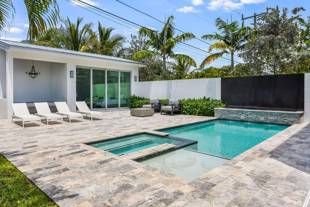 This is a unique opportunity to capture the Delray Beach lifestyle with this modern 8th avenue townhouse/villa. Built by Marc Julien Homes, this home offers contemporary beach & urban living with the Atlantic Ocean less than a mile away and only 9 blocks from Atlantic Avenue. The inside offers the latest in heigh-end finishes and modern refinement, including an industrial kitchen with gas stove & smart home features with sound, lighting and pool controls. The outdoors offers a private tropical retreat perfect for entertaining with a covered patio, summer kitchen, pool with heated spa and flamed/waterfall feature all leading to guest house complete with built-in lounge, bath & separate AC. An outdoor shower is included along with a fire pit, perfect for lounging and entertaining.