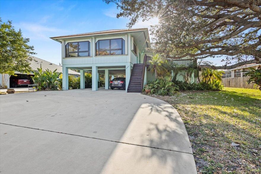 Located on North Hutchinson Island in the highly sought-after Fort Pierce Shores community, an established beachside neighborhood known for its lasting appeal, this elevated coastal home is just 2 blocks (.2 miles) from Atlantic Ocean beach access and directly adjacent to Fort Pierce Inlet State Park. Surrounded by ocean, inlet, river, and preserved natural beauty, this is a setting residents hold onto for generations. Solidly built and elevated for longevity and storm resilience, this home blends coastal lifestyle with structural confidence. Enjoy sunrise beach walks, boating, fishing, kayaking, and state park trails right outside your door. Upstairs offers 3 bedrooms and 2 baths with vaulted ceilings, skylights, Florida room and deck, plus a private 1/1 mother-in-law suite below. No HOA. The main living level features an open layout with vaulted ceilings and skylights that create an airy, light-filled atmosphere throughout. The Florida room, lined with large windows, offers flexible space ideal for relaxing, dining, or additional entertaining. The expansive wood deck extends the living area outdoors, providing a private setting to unwind and enjoy coastal breezes.

The ground level includes a fully equipped one-bedroom, one-bath apartment with its own kitchen, living area, and washer and dryer, making it well suited for extended family, guests, or income-producing potential. Covered space below provides ample parking along with storage for beach gear, boating equipment, and recreational items.

The new high-span bridge expected to open later this year will further improve access to North Hutchinson Island while maintaining the character and natural surroundings that make this area so desirable.