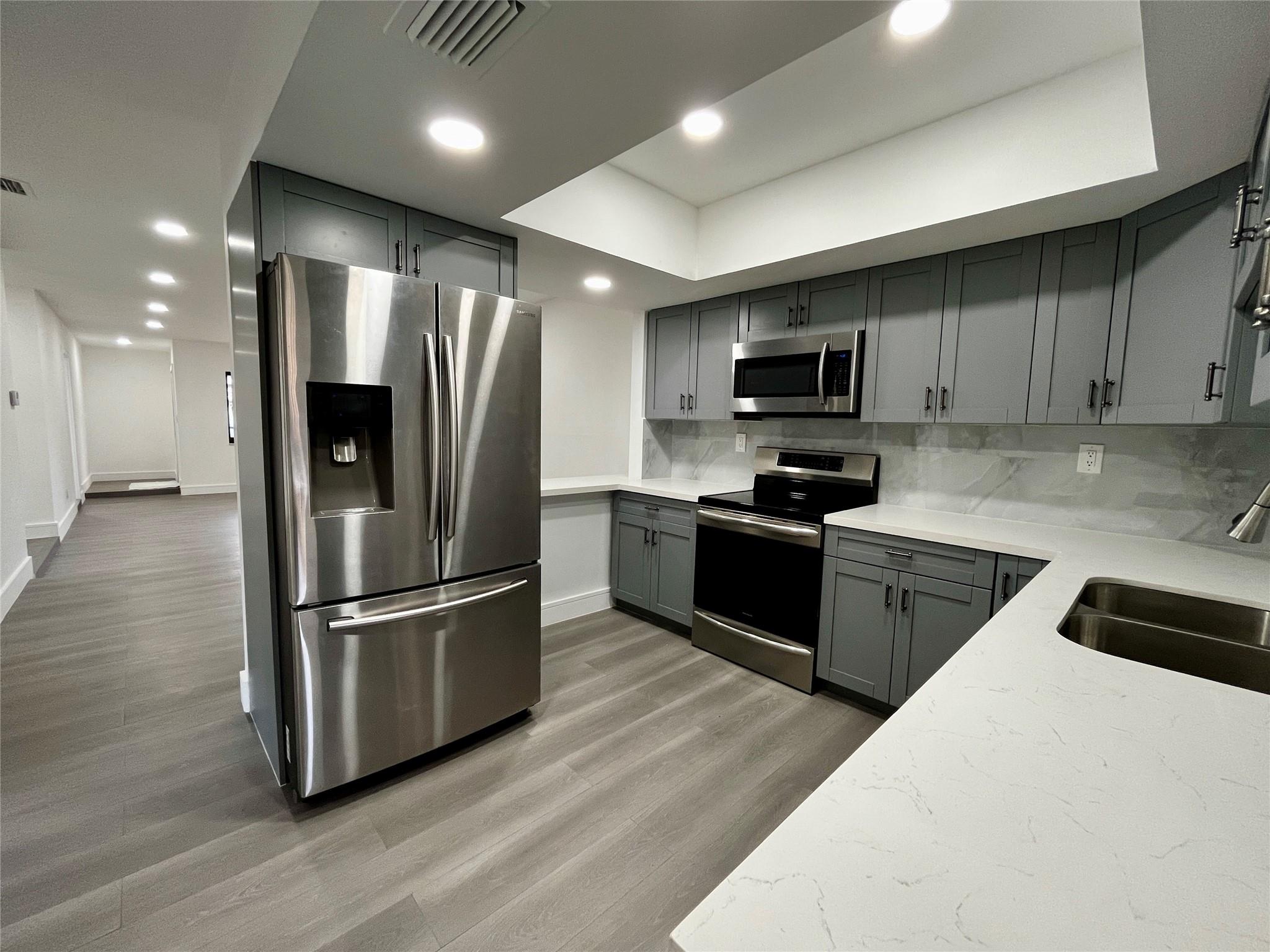 NO HOA! In the heart of Coral Springs! This fully renovated half-duplex features 3 bedrooms and 2 bathrooms, a bonus room in the back that provides extra space and can be used for an office/den or a 4th bedroom, and a fully fenced and private backyard (plants newly planted on the perimeter of the backyard will grow very tall and thick!) BRAND NEW tile roof (2025) and BRAND NEW impact windows and doors (2025) done with permits. Convenient laundry room with washer/dryer. The home boasts a modern kitchen with granite countertop, stainless steel appliances, and a bar extending into the dining room. Shops/restaurants near by and Coral Springs elementary school and middle school located in the neighborhood! Both a 5 minute walk! Live in this amazing Coral Springs neighborhood for less than 500k!