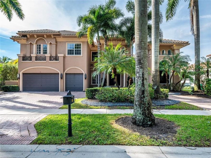 Impeccable, Modern Masterpiece! Upgraded waterfront pool estate in prestigious, gated Hawks Landing. Incredibly maintained custom 6 BR/6.5 BA ensuite +office w/built-ins + loft. Enjoy relaxing sunsets from your covered lanai overlooking oversized heated infinity pool w/spa while a waterfall fountain cascades the spectacular expansive lake. BBQ from your summer kitchen amid lush, private landscaping. Opulence abounds w/ regal entry, formal dining, custom millwork & lighting, Italian marble, gourmet kitchen w/GE Monogram appl., dbl oven,  island, Thermador, Bosch dishwasher, granite & wood cabinetry. Primary BR suite w/ walk-in closets, dual vanities, soaking tub & shower. 3-Zone AC, laundry room, butler’s pantry, & coffered ceilings, & maids quarters... Close to American Heritage School.
