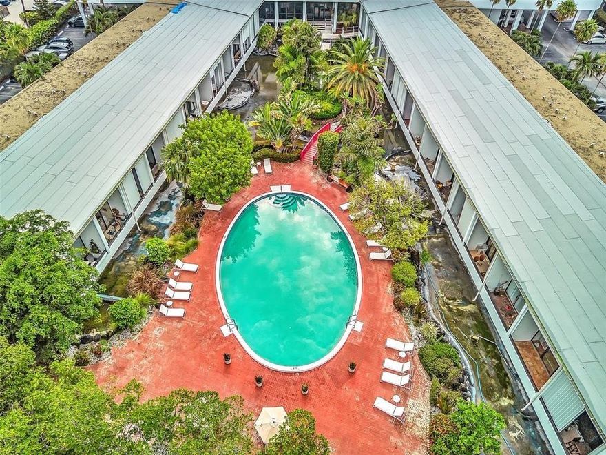 Year round vacation living in this enticing Lanai townhome with private, deeded beach access offering a sundeck with gazebo and BBQ area,  Whether you are looking for a permanent residence or a delightful vacation home, this unit will not disappoint. One bedroom & two full bathrooms. Dramatic volume ceilings. Huge impact doors open to spacious balcony with relaxing views of the lagoon, gardens and pool. Open Kitchen to Living Area. Laundry room. Upstairs bedroom with full bathroom & spacious closets. Amenities include 2 heated pools, fitness room, community room with kitchen & bathrooms, sundeck, sauna, bike room, car wash, 24 hour door person. Parking right in front. Come see for yourself to appreciate. Walk across the street to your private beach!