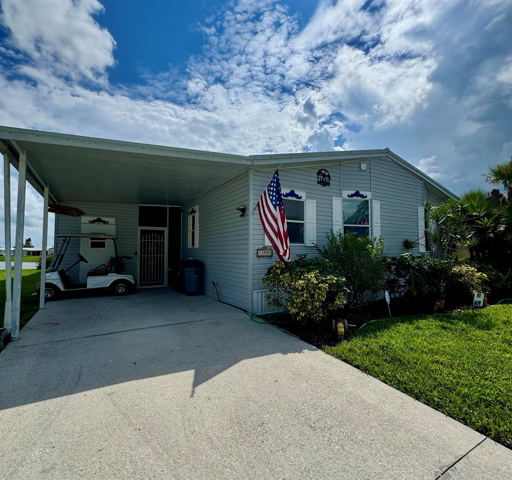 This lovely triple-wide 2-bedroom 2-bath home is in the desirable 55+Spanish Lakes Fairways community. Home is a lakeview home with a large screened-in patio overlooking the lake with a south exposure. Perfect for morning coffee or evening cocktails. This home boasts a family room as well as a living room with built-in shelves for added storage. Formal dining room. Perfect for entertaining or weekend company. Home is being sold unfurnished. Metal roof (2020), A/C (2018), Plumbing has been redone in 2024, New dryer vent (2024), New vapor barrier. New 50-gallon water heater 2024. Lawn care and trash removal are included in the lot rent. The community features two pools, tennis, pickleball, bocceball, shuffleboard, an 18-hole golf course, and much more. MUST SE