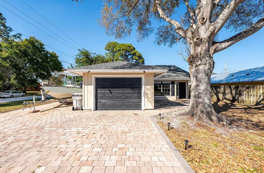 This 3-bedroom, 2-bath, garage home on a corner lot. Improvements include a 2022 roof, updated kitchen, laminate flooring, and updated plumbing, giving the home a clean and move-in ready feel. Home has a paver driveway with room for a boat or RV. No HOA! Excellent location, convenient to shopping, schools, beaches and boat ramps!