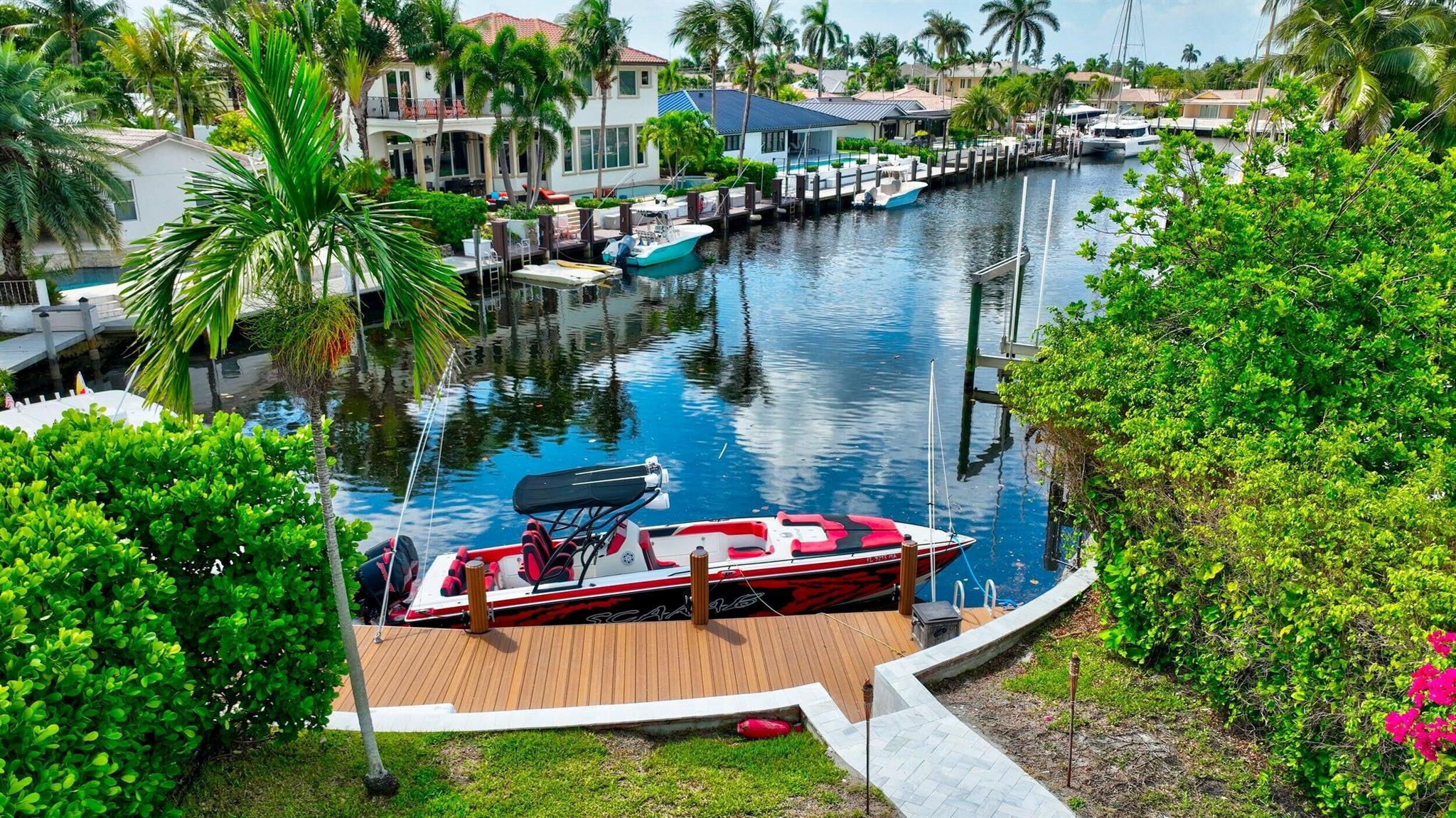 JUST BRING YOUR BOAT! Stunning, fully renovated waterfront pool home with a guest house in prestigious Lighthouse Point, just off the North Grand Canal. This 3-bed, 2-bath gem on an 11,000+ sq. ft. corner lot is a boater's paradise with deep water access and a quick ride to the Hillsboro Inlet. The guest house is perfect for visitors or extended family. Enjoy breathtaking views of the pool, patio, dock, and waterway from multiple vantage points, including the beautiful Florida room. Located just steps from Dan Witt Park Complex for easy access to outdoor activities and family fun. SEASONAL TERM RENTAL AVAILABLE AT $15,000 MONTHLY.