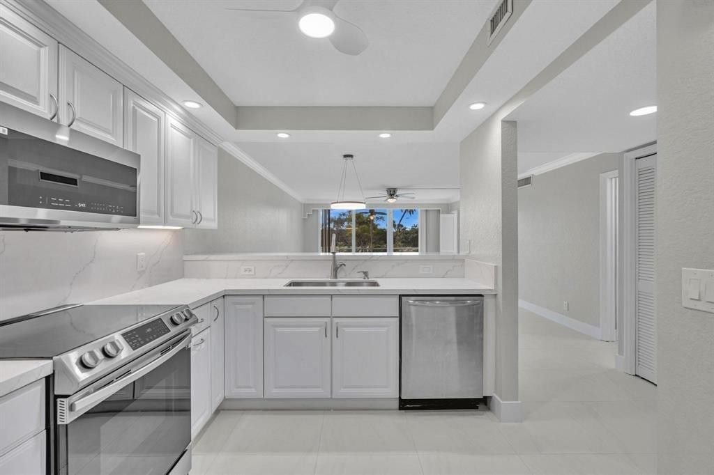 Photo of 3800 Oaks Clubhouse Drive #201, Pompano Beach, FL 33069 (MLS # F10543725)