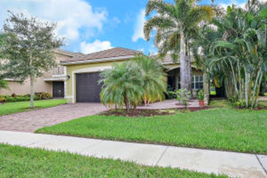 This beautiful ranch home is upgraded throughout & will please everyone. Entering you will notice the beautiful terra cotta tile throughout the home including all bedrooms. There are vaulted ceilings in all the living areas to create an open flow. The incredible kitchen features 42'' Antique White wood cabinets with crown molding & undercabinet lighting. In addition there are stainless steel appliances & granite counters. The large dining room has plenty of room for entertaining. The oversized family room includes stunning lake views. The large master suite has 2 walk-in closets & a very upgraded master bath with Antique White wood cabinets. The home also features French doors to the screened patio overlooking the serene lake. Most windows have plantation shutters. Do not miss this home!