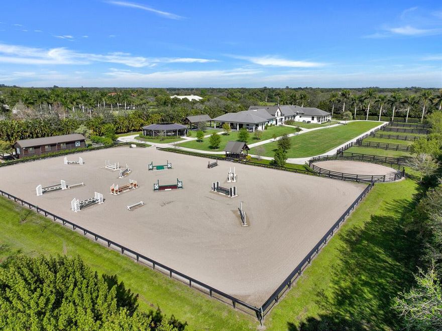 An equestrian paradise located in Palm Beach Point East! Situated on 5 beautifully manicured acres this stable features 2 barns totaling 20 stalls. Center aisle 16 stall main barn with custom cedar wood tack room & lounge. Newly constructed 6 horse covered walker, 8 covered grooming stalls, and approx. 2000 ft. circular bridle path. The property also features 2 apartments. The first is 2 beds, 2 baths complete with cathedral ceilings and luxury finishes. Second apartment is 2 beds, 1 bath with a full kitchen and large living space. A covered viewing area overlooks a 220' x 140' irrigated GGT all-weather arena. This property is complete with 5 paddocks and a 60ft round pen w/ all-weather footing. Don't miss the opportunity to own this thoughtfully designed stable perfect for any equestrian.