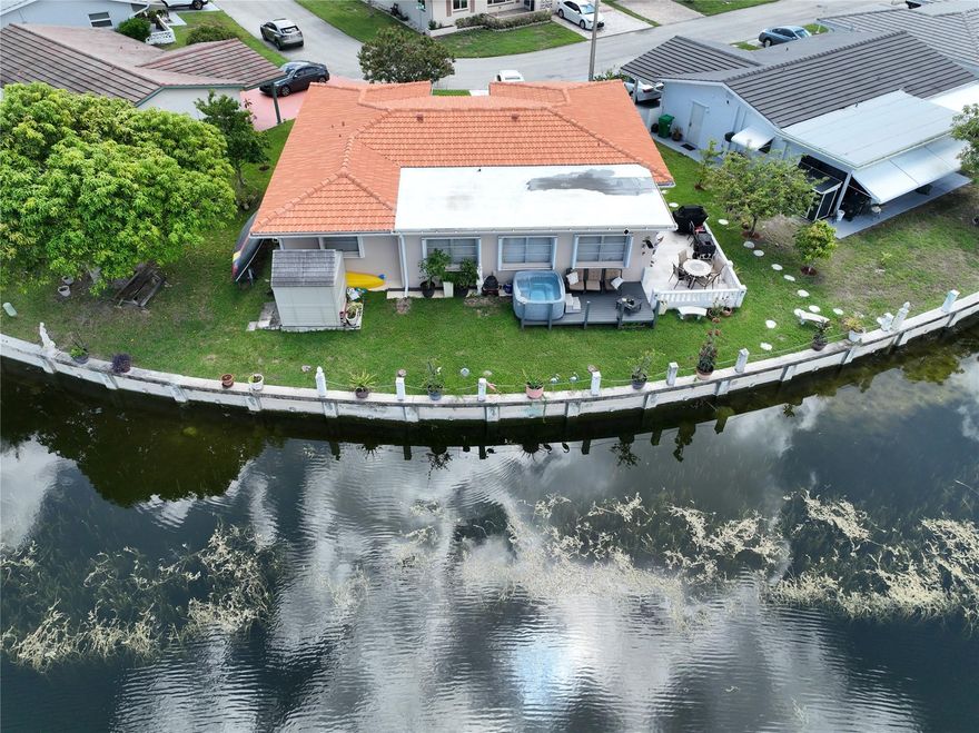 Stunning waterfront home in Mainlands of Tamarac. Experience the perfect blend of elegance and comfort in the beautifully updated waterfront home. Step into a spacious living room, followed by a separate dining area and a modern kitchen featuring granite countertops, stainless steel appliances and a cozy breakfast nook. The large master suite boasts a remodeled bathroom and the generous second bedroom also includes an updated bathroom. Enjoy breathtaking water views from the Florida room and backyard, perfect for relaxing or entertaining. Additional highlights are separate laundry room with a washing tub, oversized lot with fruit trees, hot tub and a shed, new roof (2019), newer a/c and water heater. Low HOA fee in a 55+ community. Fishing allowed. A true must see! Schedule showing today.