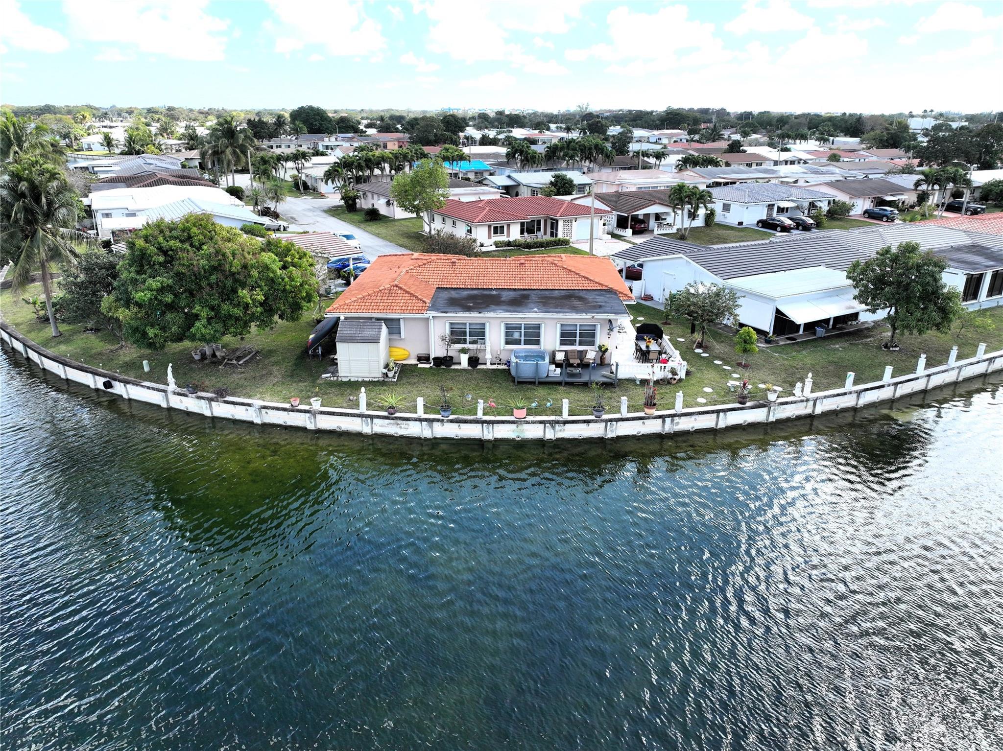 Stunning waterfront home in Mainlands of Tamarac. Experience the perfect blend of elegance and comfort in the beautifully updated waterfront home. Step into a spacious living room, followed by a separate dining area and a modern kitchen featuring granite countertops, stainless steel appliances and a cozy breakfast nook. The large master suite boasts a remodeled bathroom and the generous second bedroom also includes an updated bathroom. Enjoy breathtaking water views from the Florida room and backyard, perfect for relaxing or entertaining. Additional highlights are separate laundry room with a washing tub, oversized lot with fruit trees, hot tub and a shed, new roof (2019), newer a/c and water heater. Low HOA fee in a 55+ community. Fishing allowed. A true must see! Schedule showing today.