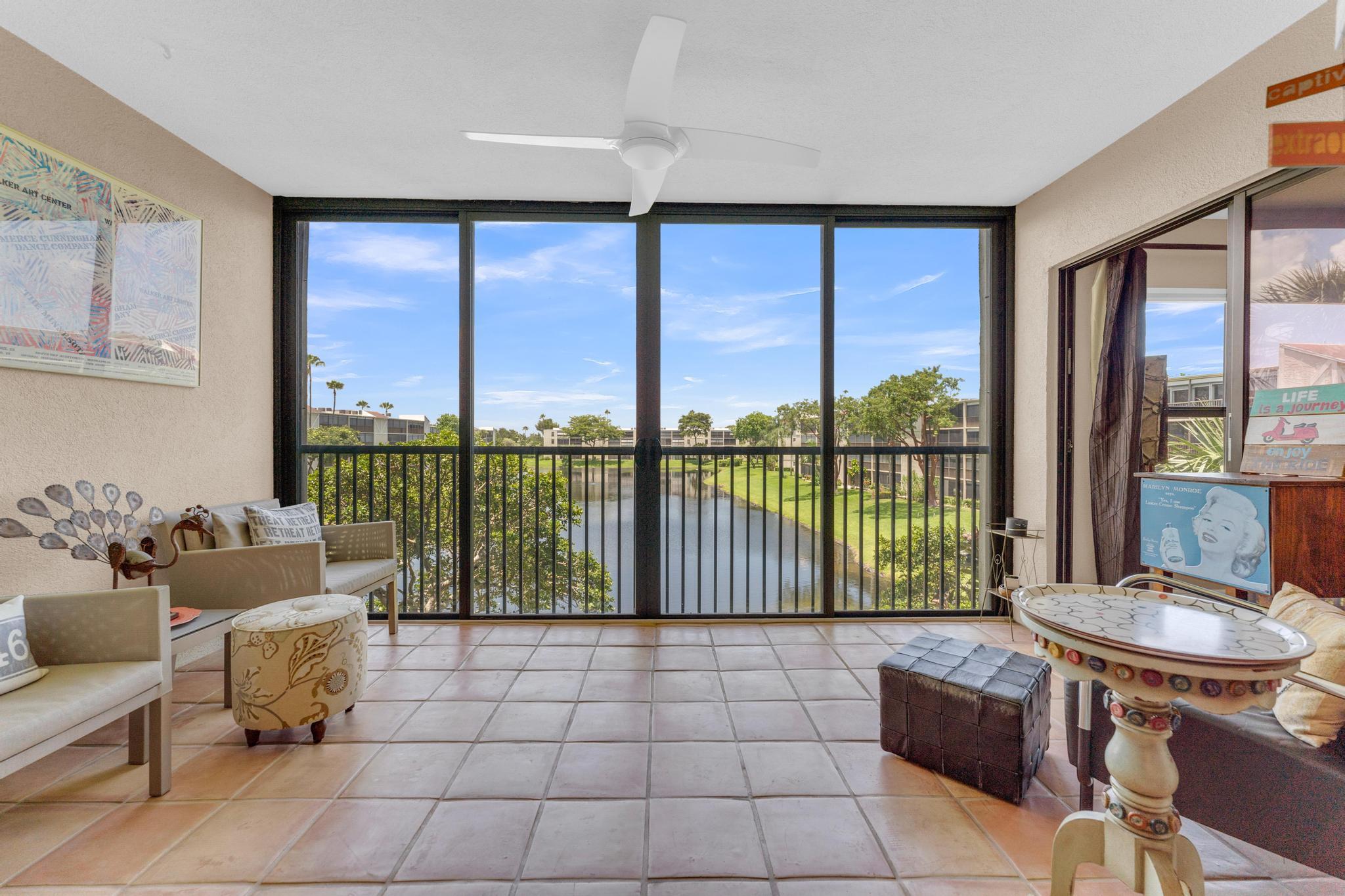 Welcome to this gorgeous lake view condo. This is the Buckingham model. Largest in the community. Stunning, updated unit in mint condition. Warm and inviting colors. Shows like a model. Freshly painted! HURRICANE IMPACT windows and sliding doors for full protection from the elements. The balcony has been totally opened to be a part of the living area. Sliding doors are gone!!! Large lovely diagonal rectified tile in the living area. High end vinyl flooring through the bedrooms. Beautifully renovated eat-in kitchen w/ high end wood cabinetry and granite countertops. Open and bright living, dining area w/ wet bar. X-large main bedroom w/ sitting area, 2 large walk-in closets, and tastefully updated bathroom. Large guest bedroom. Updated bathroom w/ shower. Separate laundryroom.