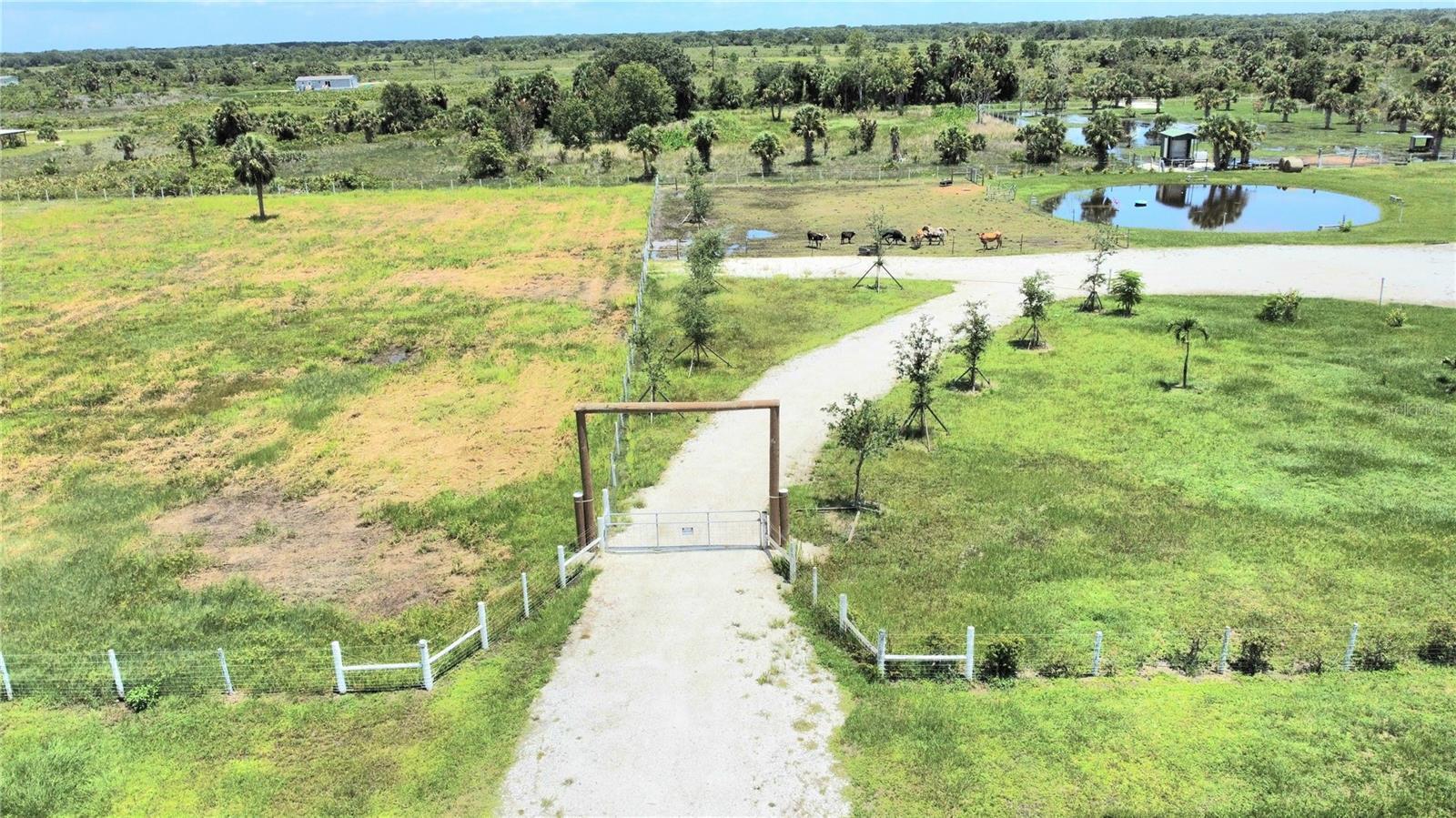 Prairie Gem~ Beautiful natural scenery and peaceful country setting, this property presents an exceptional opportunity for those seeking a rural lifestyle. 6.25 Acre lot ideal for horse lovers and livestock are welcome. Create your own personal oasis with plenty of space to room or consider the potential for agricultural use. The property offers mature trees and expansive pastures and fields . Enjoy the wide open spaces nicely treed and fully freshly painted fenced/crossed fenced and gated by both sides. Access roads NW 274th St & NW 276th St. Deep water well and pump system. Electric service. Softener water system. Septic. (2) 30 AMP outlet for RVs. Sprinkle valve system. Culverts. Deep/beautiful pond loaded with fish plus relaxing pond deck. Bring all your toys or come build your dream