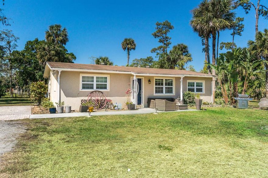 Quaint 3 bedroom and 2 bathroom ranch home perfectly situated on 2.5 acres. This lovely property has been fenced, cleared and is ready for your dream equestrian build-out. It’s in a prime location just one block from Southern Blvd and only 5 miles from The Palm Beach International Center in Wellington. Enjoy country living with all the amenities of Wellington just minutes away. The home features a split floor plan, recently updated, and new interior paint. The property is high and dry with recent fill added. It also has RV hook-ups and 2 storage sheds. This property is a must see and won’t last long.