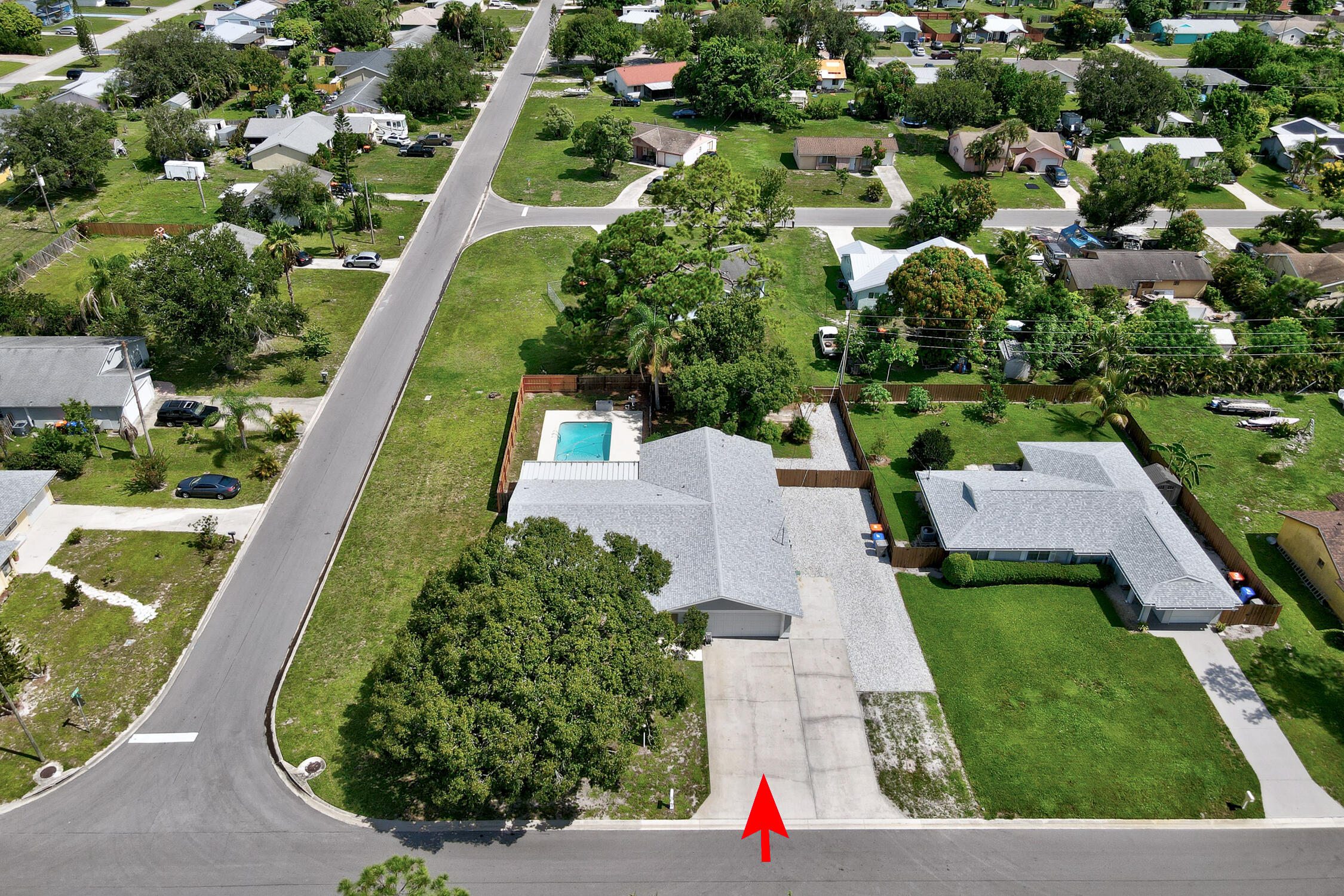 Rare opportunity to own .34-acre corner lot. 4-bedroom 2 bath 2 car garage with a pool. This house features and extra wide driveway with additional parking on the side of home. New roof 2024, Water heater 2025, a/c 2017, new sliding impact doors 2025, mar sited pool. County water and sprinklers system is on well.Freshly painted inside and out. 18-inch tiles and laminate wood floors. Formal living, dining, and family rooms. Primary suite has walk-in closet and new sliding doors to pool area. Large kitchen with matching stainless-steel appliances, a large peninsula bar area and a pantry. This is a great home and is move in ready