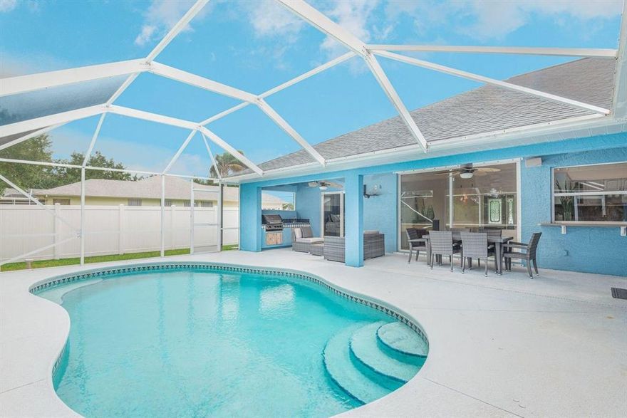 Welcome home to your new privy backyard perfect for entertaining & concealed from the public. This pool home backs up to a bird sanctuary oasis that will never be built upon. There are multiple sets of oversized slider doors throughout the home that open to the pool screen enclosure allowing you to bring the outdoors inside. The pool area even offers a fully loaded summer kitchen perfect for family gatherings. Check out the tongue and groove detailed outdoor ceiling! The expanded driveway was created for your boat/RV as there are no HOA restrictions. Come experience the expansive vaulted ceilings & porcelain tile throughout the living areas, updated LVP in the bedrooms. ''Her'' Master closet has custom shelving.  All new upgraded luxury stainless steel appliances including the washer/dryer