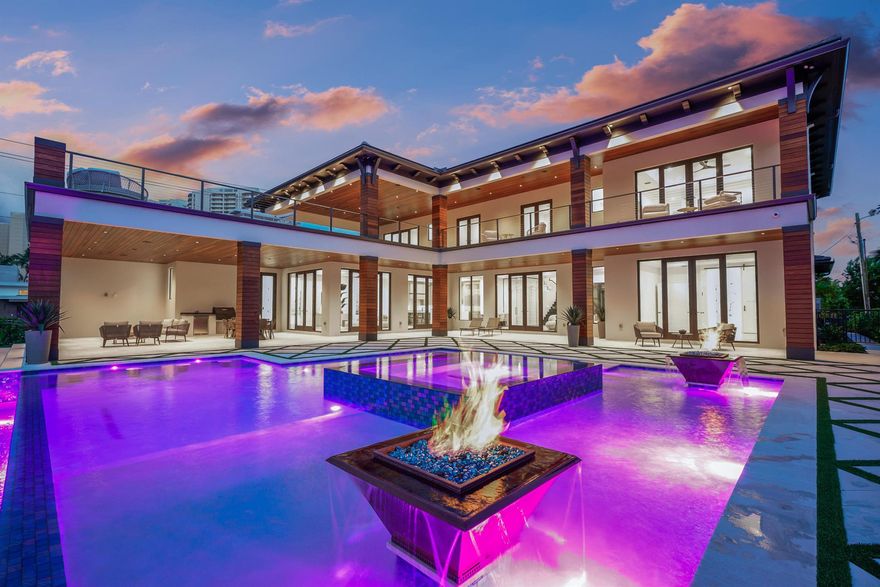 BRAND NEW CUSTOM WATERFRONT home with new dock and new bulk head and batter piles on wide, deep water minutes to the Palm Beach Inlet! An amazing location by boat or car, this home offers 6 bedrooms, 7.5 baths, 4 car garage and an expansive saltwater pool and outdoor entertaining area with over 1000sqft of open sun deck. Beautifully designed kitchen with double islands and hidden walk-in pantry. Flexible floorplan offers first and second floor primary suite options, first floor guest suite, two upper level guest bedrooms, loft and bonus/media/optional 6th bedroom. Smart home capabilities, private elevator, wine display, fireplace and outstanding pool amenities. Lush landscaping and spacious backyard provide the ideal setting for entertaining. The beach is only a short 2 minute walk away!