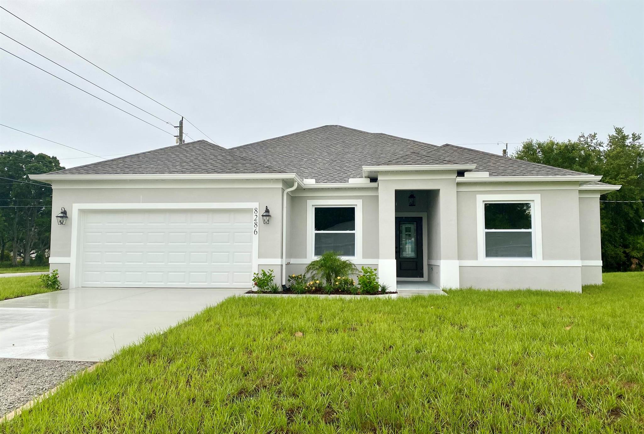 Be the FIRST to live in this stunning brand new build with loads of premium upgrades. This home features 4 bedrooms and 2 baths on an oversized corner lot. This home was built with meticulous attention to details including tray ceilings in living and primary bedroom, upgraded 42 in. cabinets with soft close drawers in kitchen/baths with quartz counter tops, upgraded lights/faucets throughout, tile flooring throughout, stainless steel appliances and remote fans/lights in rooms. Each of the 4 bdrms. also boasts walk in closets, with the primary bath featuring smart mirrors! No worries with upcoming storms since the windows and doors are hurricane impact. This home is centrally located and close to the highway! Perfect for growing families and NO HOA to worry about! Come take a look today.