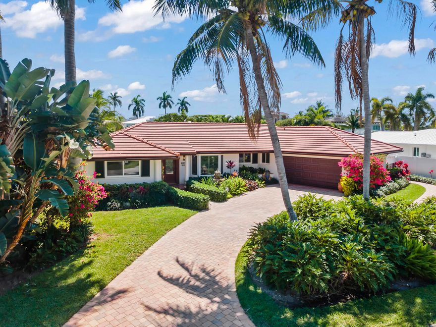 Experience the ultimate South Florida lifestyle in this stunning waterfront retreat located in the highly desirable Tropic Isle neighborhood of Delray Beach. Boasting 90 feet of prime southern exposure water frontage, this beautifully maintained 3-bedroom, 2-bath home offers the perfect blend of comfort, style, and coastal living.  Step inside to find an updated kitchen, complemented by impact windows throughout for peace of mind. The home features a newer A/C system and a recently updated pool filter, ensuring efficiency and ease of maintenance. Outdoors, the property truly shines. Enjoy a private, well-landscaped backyard oasis complete with a sparkling pool—ideal for relaxing or hosting guests. For boating enthusiasts, this home is fully equipped with a boat lift, jet ski lift, and a dedicated kayak dock, providing effortless access to the water. Perfectly situated, you're just a 10-minute walk to the beach and only a 5-minute drive to vibrant downtown Delray Beach, where dining, shopping, and entertainment await. This is more than a home—it's a lifestyle. Don't miss your chance to own a slice of paradise.