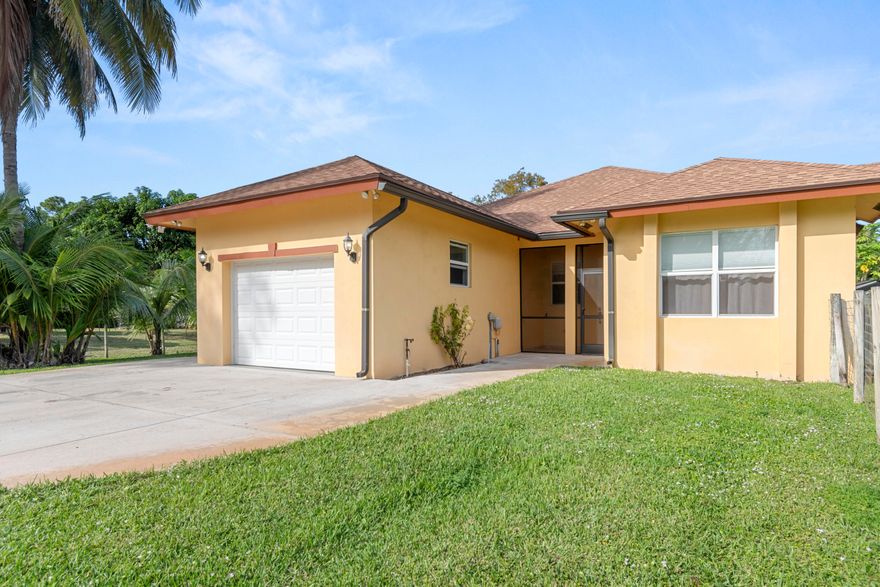 RENT INCLUDES WATER AND ELECTRICITY! Discover tranquility and convenience in this modernly designed, private accessory dwelling single family residence located in highly desirable Western Lake Worth, bordering Wellington. Designed for sophisticated living, offering two spacious bedrooms, each with its own full bathroom. The interior boasts volume ceilings and tile flooring throughout, enhancing the abundant natural light. The heart of the home is the true chef's kitchen featuring beautiful granite countertops, soft-close cabinets providing ample storage space, stainless steel appliances and a stylish glass-door pantry. No expense was spared on the finishes, which extend to the bathrooms, where both are adorned with granite counters and feature separate, large walk-in showers. Enjoy the Florida outdoors from the spacious, screened-in patio. Essential convenience is provided by the attached one-car garage for parking and extra storage. This is a rare opportunity to rent in a sought-after, convenient location.This property offers a quiet escape while being ideally situated near the Florida Turnpike and US-441, with easy access to premier destinations like City Place, Delray Beach and Lake Worth Pier.