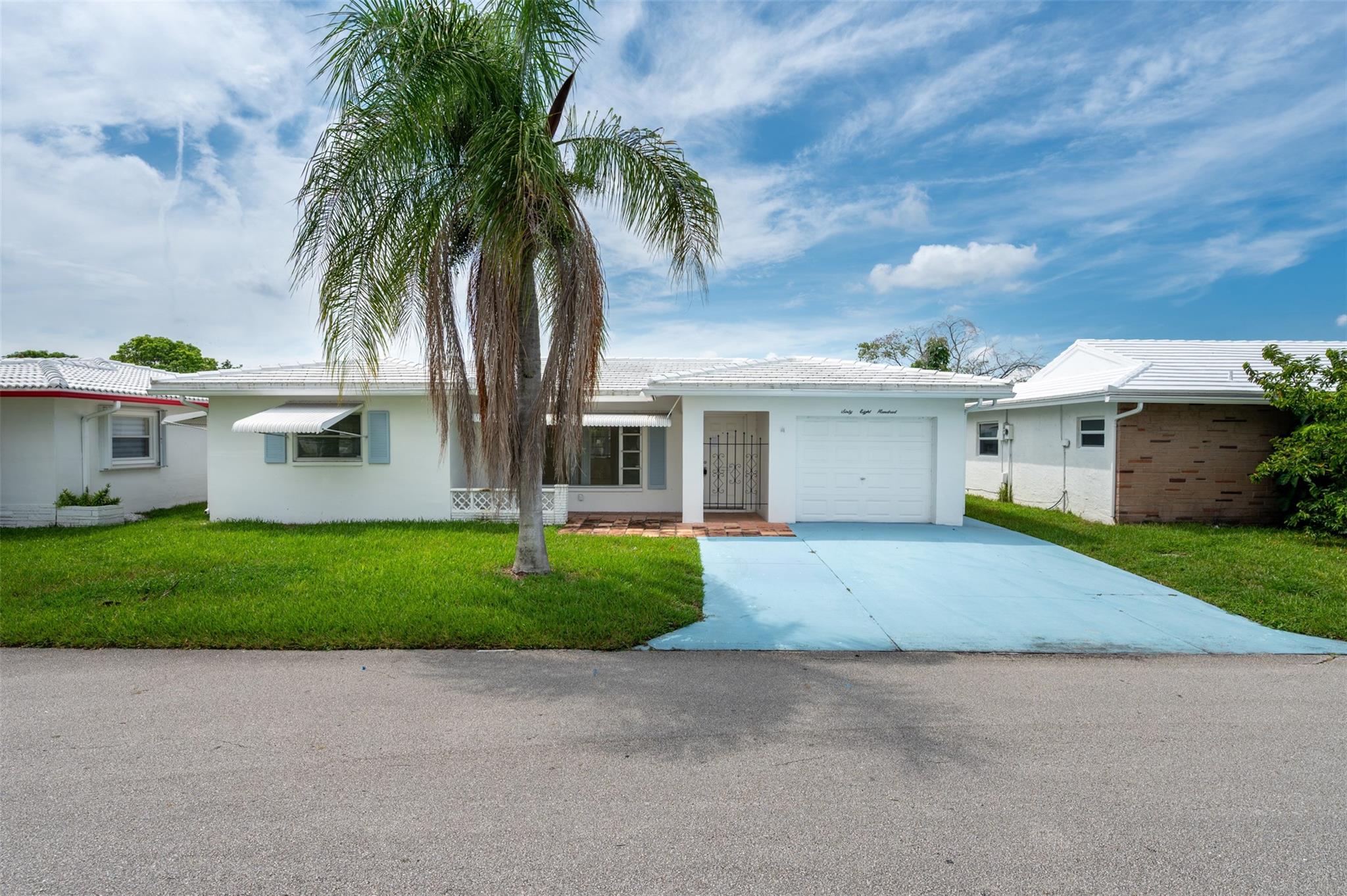 Welcome to The Mainlands of Tamarac Lakes, a quiet and pristine 55+ community offering low-maintenance living and a strong sense of connection. This bright and inviting 2-bedroom, 2-bathroom home features fabulous water views, a spacious yard perfect for visiting grandchildren, and a charming Florida room filled with natural light. Enjoy the convenience of a one-car garage and a separate laundry room. The community maintains your lawn and handles exterior painting, allowing more time to enjoy the many recreational amenities. Inside, a neutral palette awaits your furniture and personal touches.