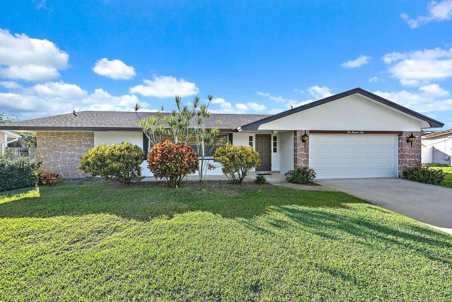 Welcome to this charming 3-bedroom, 2-bath home, situated on a generous .28-acre lot & located within county-ordinances that provides cost-effective taxes, fewer restrictions, & larger lot sizes. This home is well maintained with a 2021 roof, accordion 2021 accordion shutters, & the central air conditioning was replaced in 2018, giving peace of mind about major systems. The lot is large and meticulously landscaped, offering ample outdoor space for recreation, gardening, or relaxation. Inside you'll find two roomy living areas perfect for everyday living or entertaining guests. A covered patio overlooks the expansive yard and includes a passthrough window to the kitchen; ideal for outdoor dining. This property blends valuable upgrades, generous living space, & affordability.