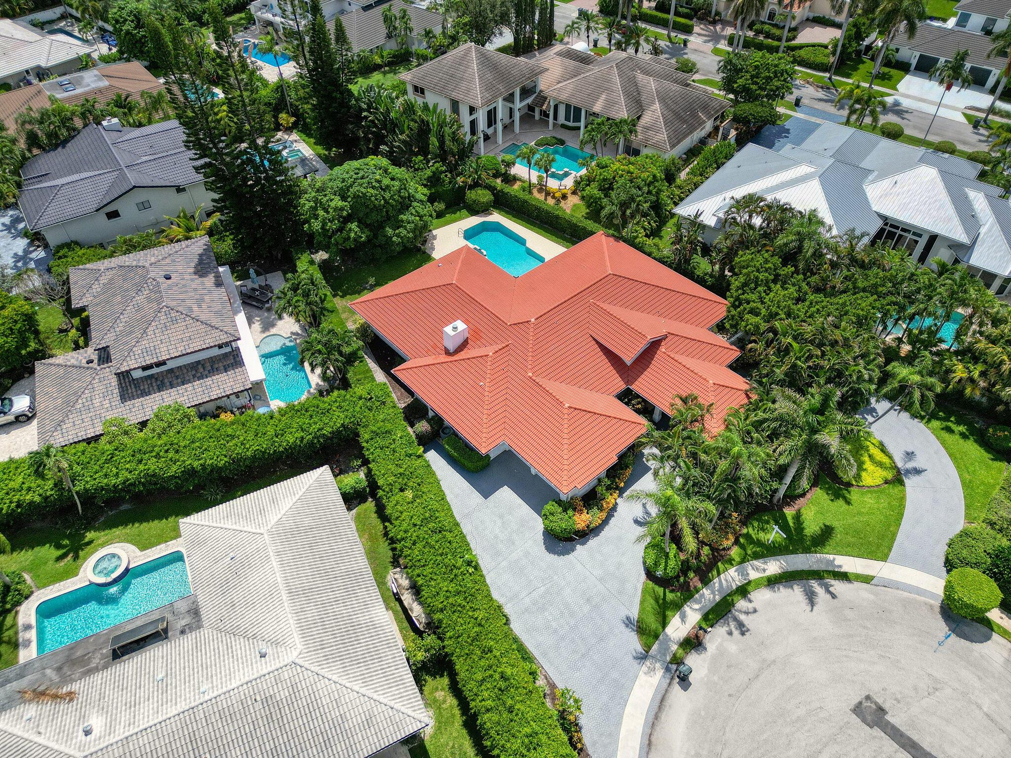 Nestled on an expansive, nearly half-acre lot (19,700 square feet) with mature, lush vegetation, this charming single-story home is set on a tranquil cul-de-sac in the highly sought-after Tropic Isle neighborhood. Offering 3,538 Ft under a/c, the residence features four bedrooms, a spacious eat-in kitchen, formal dining and family rooms, a welcoming living room, laundry area, and a versatile den. The generous primary suite includes a walk-in closet for ample storage. Perfect for entertaining, the backyard showcases an inviting swimming pool and an expansive pool deck surrounded by serene greenery. With no HOA, this property combines elegance, privacy, and convenience in an ideal Boca Raton location
