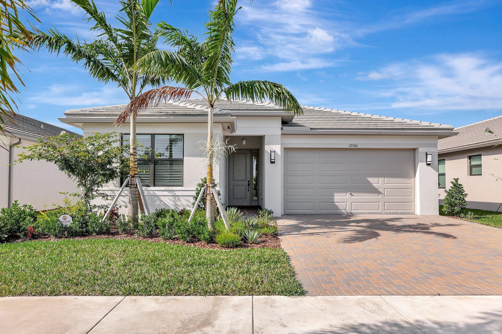 This barely 1 year old Sandpiper model in Valencia Walk is pristine with a warm and charming feel. It has beautiful crown molding in the main living areas and plantation shutters on all the windows. The kitchen is a dream with a vented canopy hood over the natural gas range, upgraded refrigerator, microwave and dishwasher, coordinating tile backsplash, glass cupboard inserts on either side of the canopy hood to showcase special items, upgraded pantry doors. Custom lighting is located throughout the home. Luxury Vinyl throughout, no carpet. The primary shower has 12x24 tiles to the ceiling and 2x2 mosaic tiles on the shower floor. The bathroom floor has 24x24 rectified matte tiles. The 2nd bath shower has tile to the ceiling with a 3'' band of Listello. Other upgrades include: tankless hot