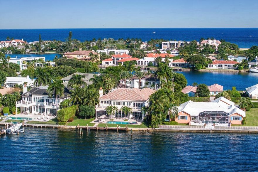 Exquisite 2-story Mediterranean waterfront home in secure, exclusive Manalapan Built by the famed luxury Hampton builder Farrell, this incredible 6,214 SF home has 5/BR and 6.5/BA and provides spectacular views and direct access to the deep, wide water Intracoastal Waterway. Enter the arched front door into the open floor plan with gorgeous marble and wood flooring and crown molding throughout. The 12ft height living room has an open bar area and wine room and there are custom French doors lead to the outdoor loggia, heated pool, spa, and dock. Many of the home's rooms feature unique tray ceilings, and all have custom crown molding finishes. The Christopher Peacock gourmet kitchen features commercial grade stainless steel appliances, a gas range, a spacious granite counter breakfast bar