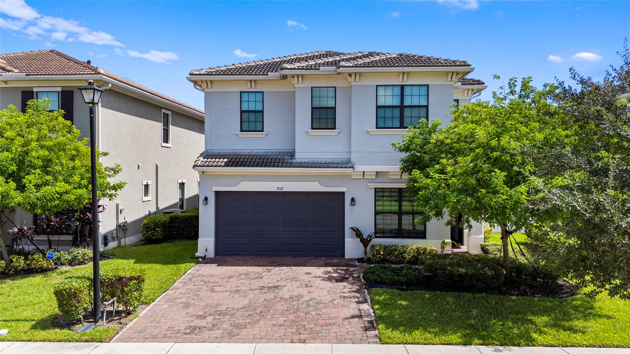 Experience waterfront tranquility and smart living in Coral Springs premier gated community, built in 2020. This 4-bedroom, 3.5-bathroom home offers 3,077 sq ft on a 6,150 sq ft lot, with water views from the terrace, living room, dining area, and master suite. Open-concept layout features a modern kitchen with island and marble tops, electric fireplace, and impact windows & door. A den with garden views can serve as a 5th bedroom, and a private office offers flexibility. Upstairs, a family room, laundry room, and luxurious master suite await. This smart home includes surround sound, cameras, and a fenced backyard with artificial turf and terrace. Enjoy resort-style amenities: clubhouse, fitness center, pool, jacuzzi, playground. Steps from University Drive’s dining, schools, and shopping.
