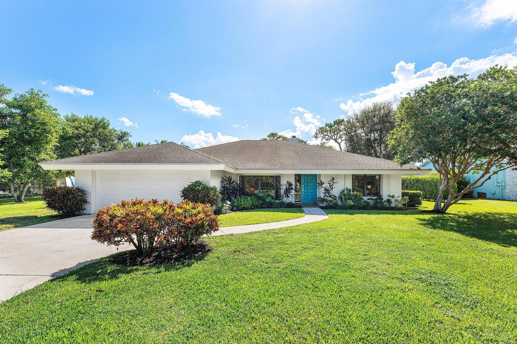 Charming 3-bedroom, 2-bathroom CBS home set on a sprawling half-acre lot with tranquil lake views and southern exposure! This home is surrounded by mature trees that have stood for decades, features an inviting pool, a two-car garage, an open floor plan, and a Springwell water softener and filtration system for pure, clean water throughout. Nestled in the picturesque Whispering Trails community, enveloped by vibrant landscaping. Highlights include an extended driveway, a spacious primary suite, soaring vaulted ceilings with exposed beams, a central vacuum system, dual water heaters, and expansive living and family rooms anchored by a cozy fireplace. The large covered patio overlooks a beautiful inviting pool and serene lake, creating an ideal setting for entertaining. Low HOA fees